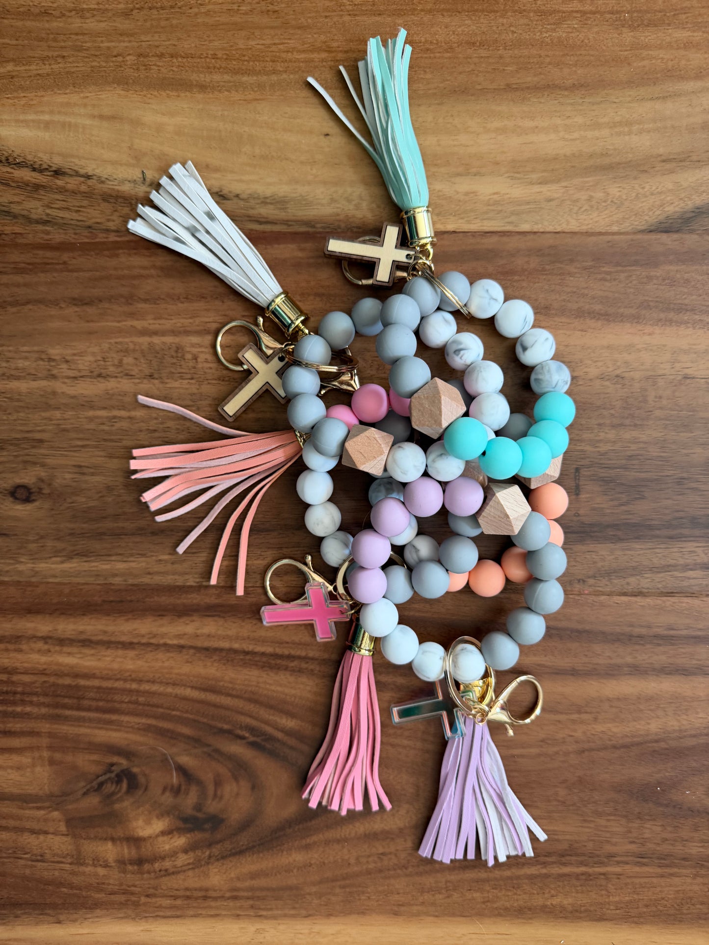 Silicone Cross bracelet keychains from Sons & Daughters, colorful accessories with cross-shaped design, ideal for everyday use.