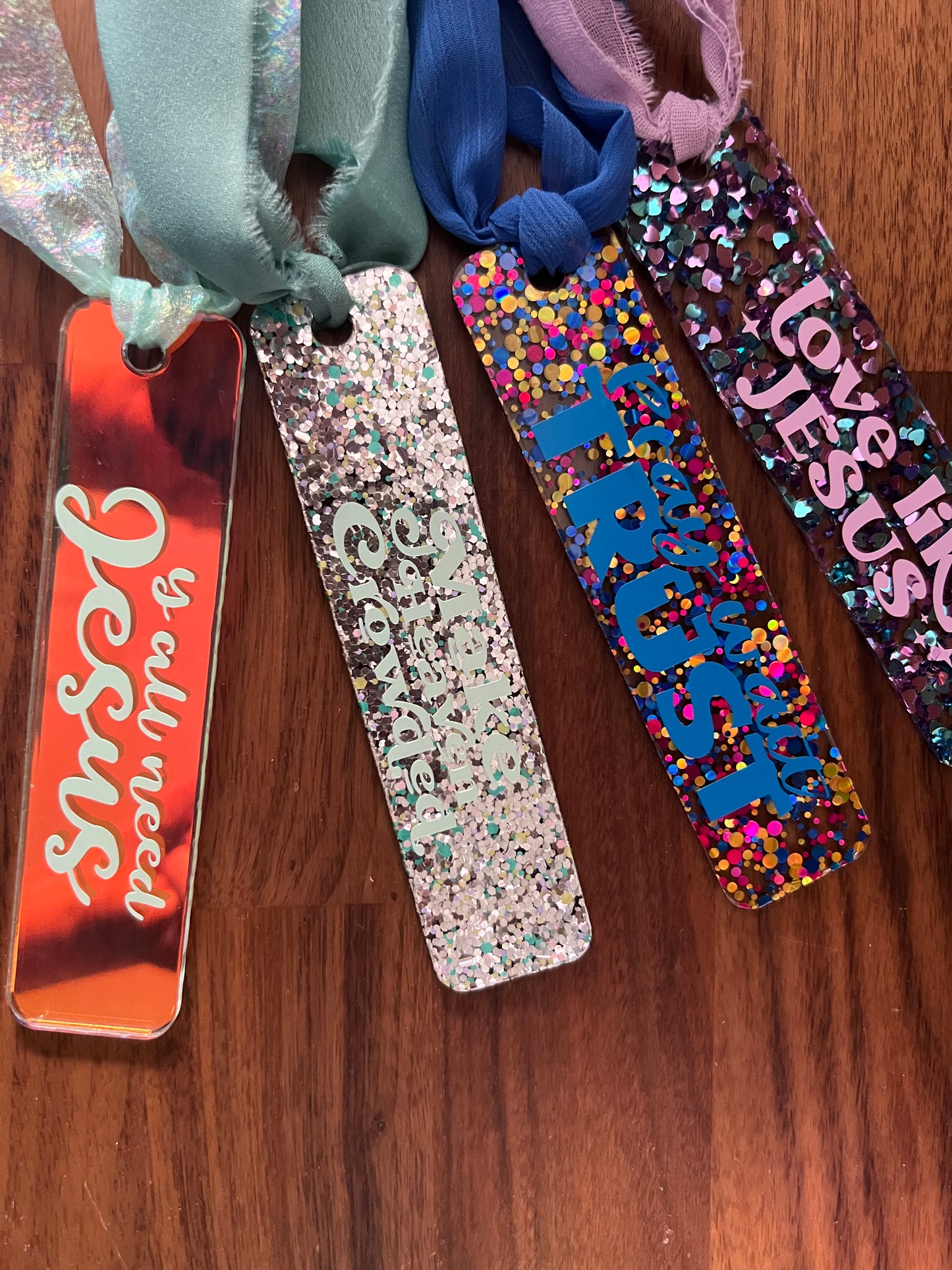 Sons & Daughters glittering acrylic bookmark with shimmering design, perfect as a gift for book lovers.