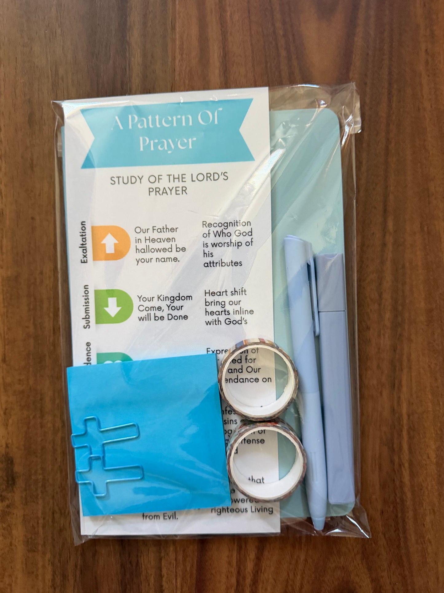 Sons & Daughters prayer kit featuring Lord’s Prayer bookmark and journal with patterned design for spiritual reflection.