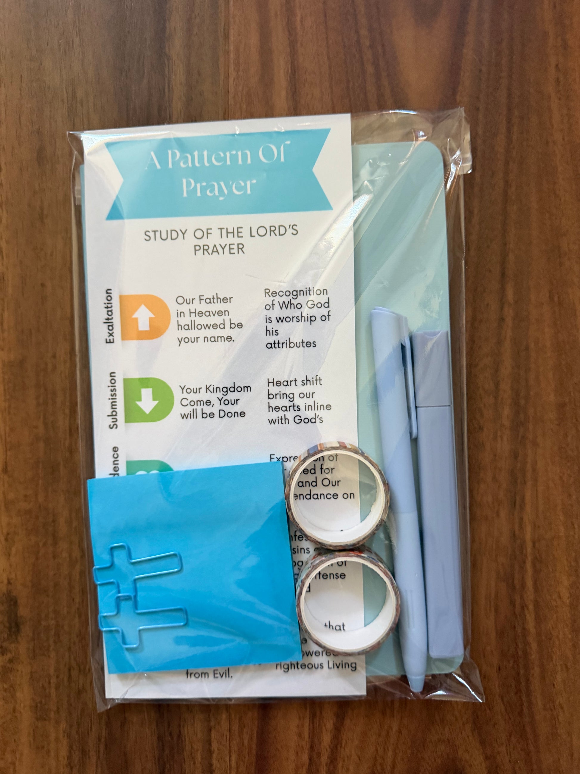 Sons & Daughters prayer kit featuring Lord’s Prayer bookmark and journal with patterned design for spiritual reflection.