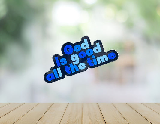 Close-up of a religious wall sign reading "God is good all the time" in decorative script, designed for spiritual home decor.