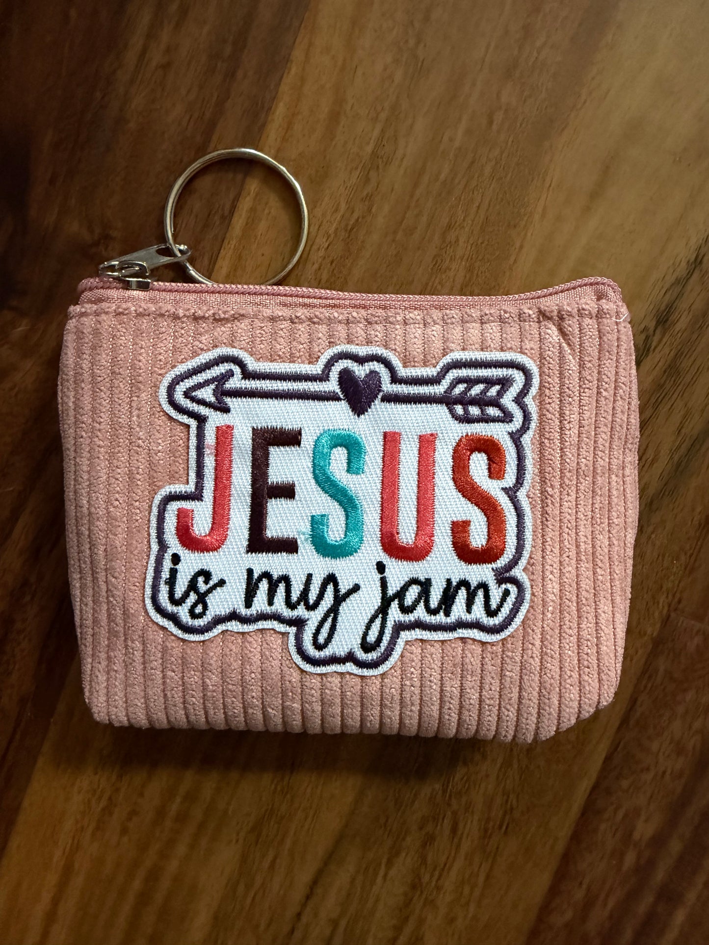 Colorful corduroy coin purse with Christian patch from Sons & Daughters accessories collection, featuring vibrant fabric and decorative details.