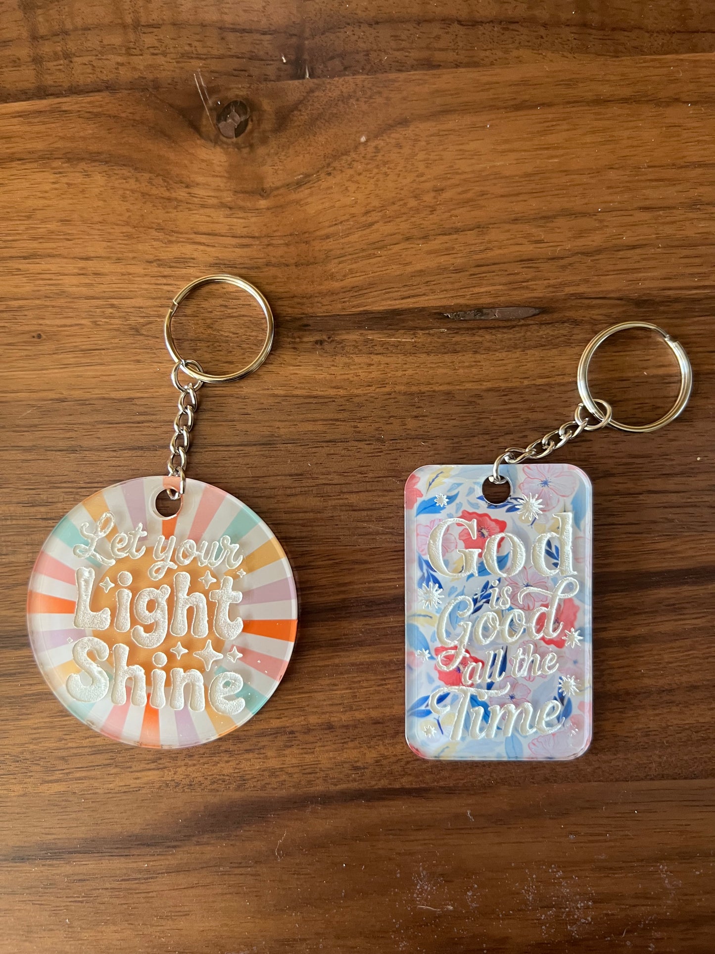 Sons & Daughters Kingdom keychain or bag tag featuring a detailed crown design on a silver-tone metal surface.