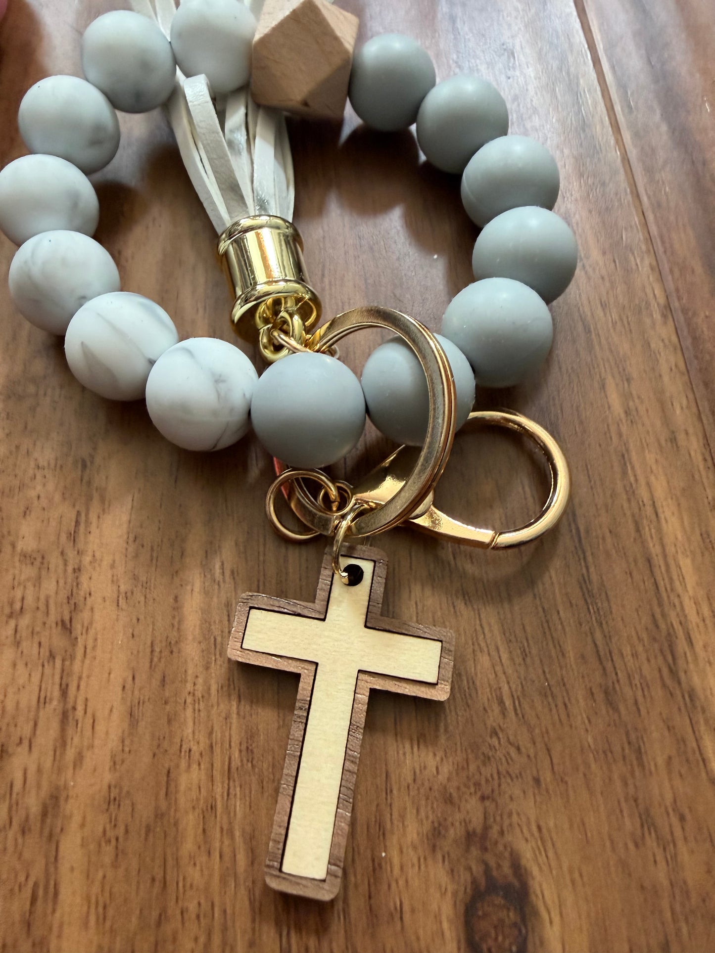 Silicone cross bracelet keychain in vibrant colors, accessory by Sons & Daughters featuring a stylish cross design.