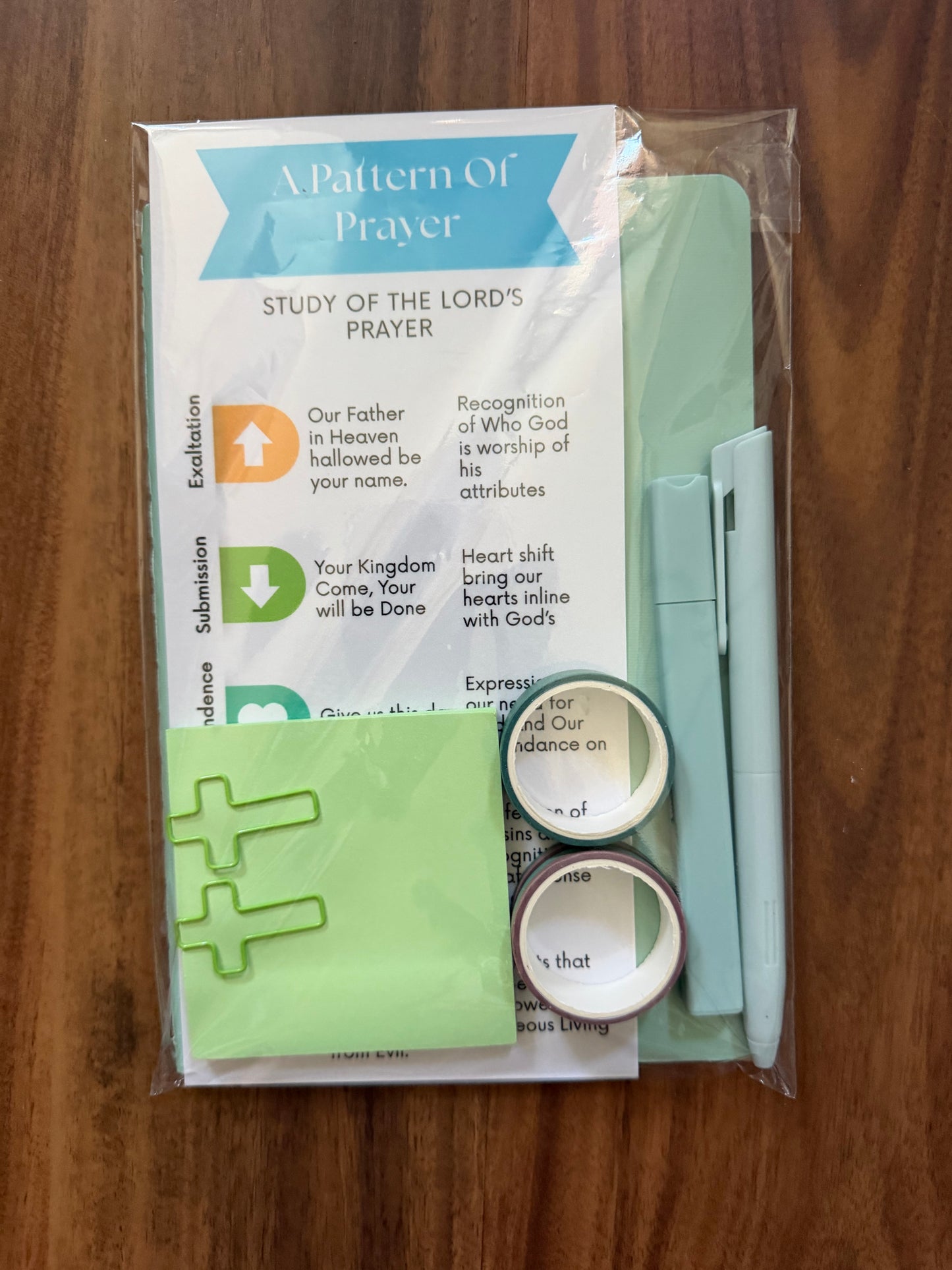 Sons & Daughters prayer kit featuring a Lord’s Prayer bookmark and journal with patterned stationery for devotional writing.