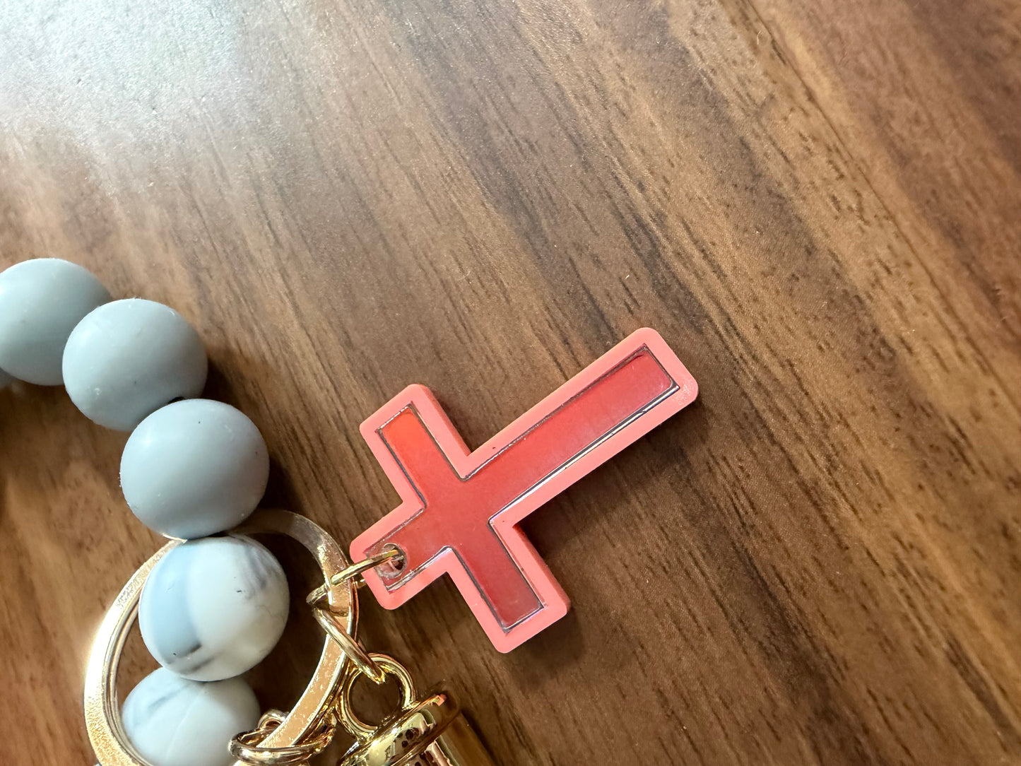 Silicone cross bracelet keychains from Sons & Daughters, colorful accessories with a 3D cross design, ideal for personal style.