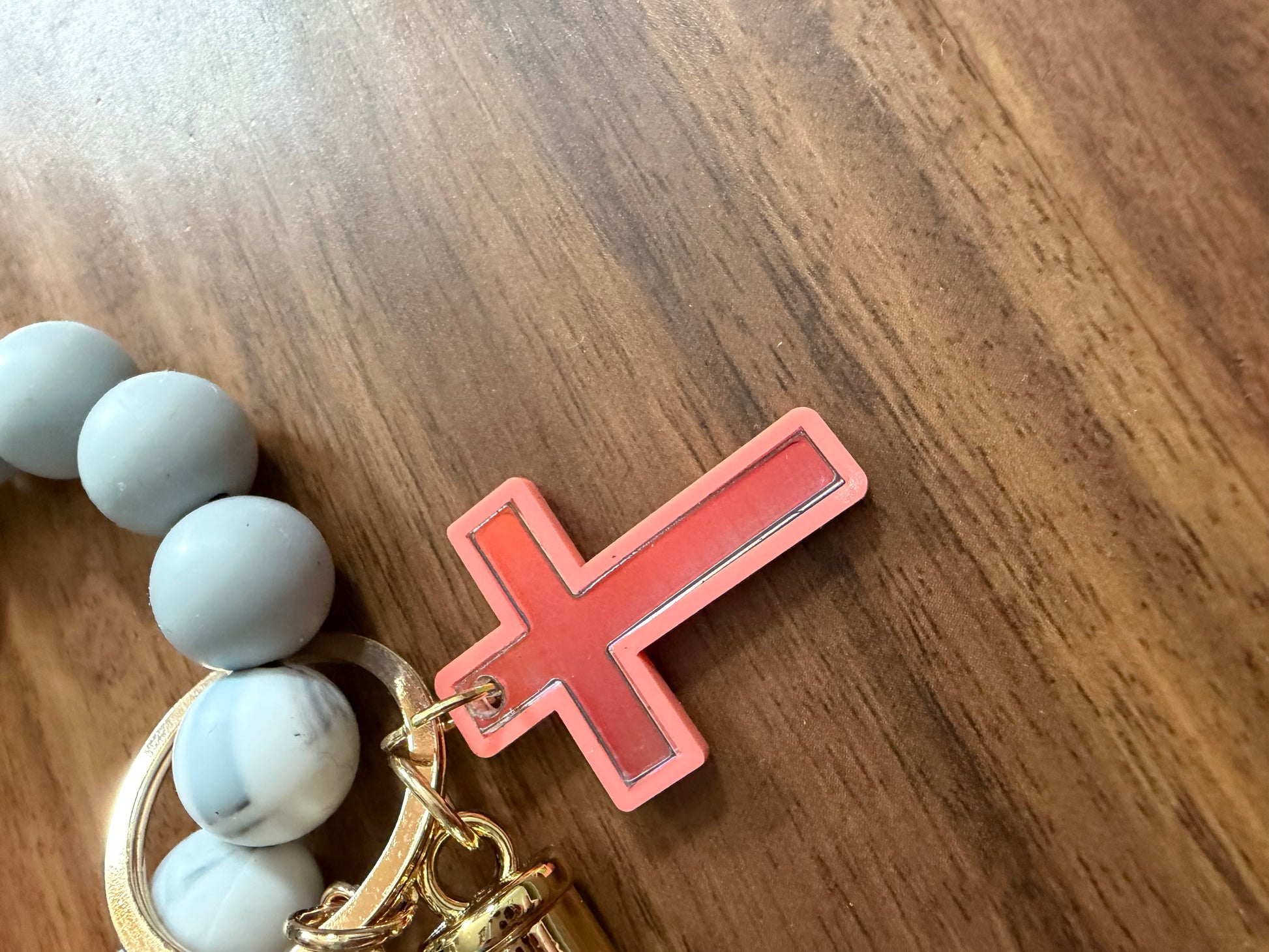 Silicone cross bracelet keychains from Sons & Daughters, colorful accessories with a 3D cross design, ideal for personal style.