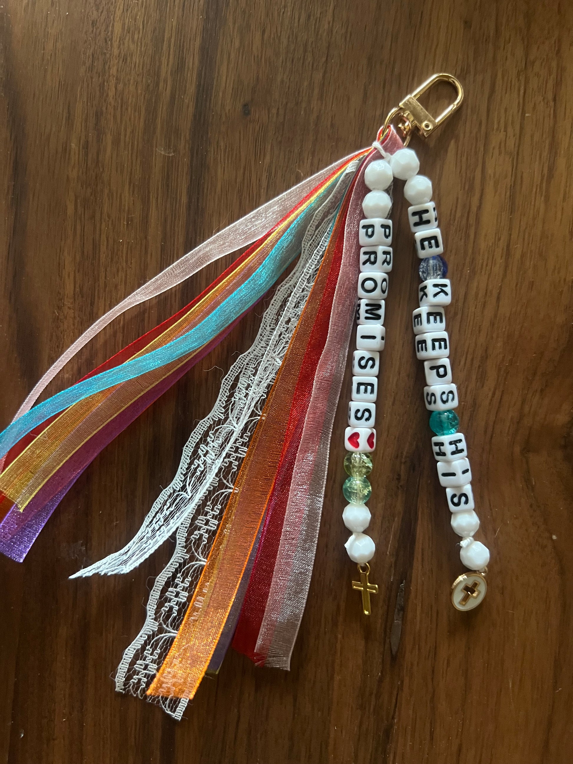 Colorful Sons & Daughters "He keeps His promises" keychain with engraved text and metal keyring, vibrant and durable.