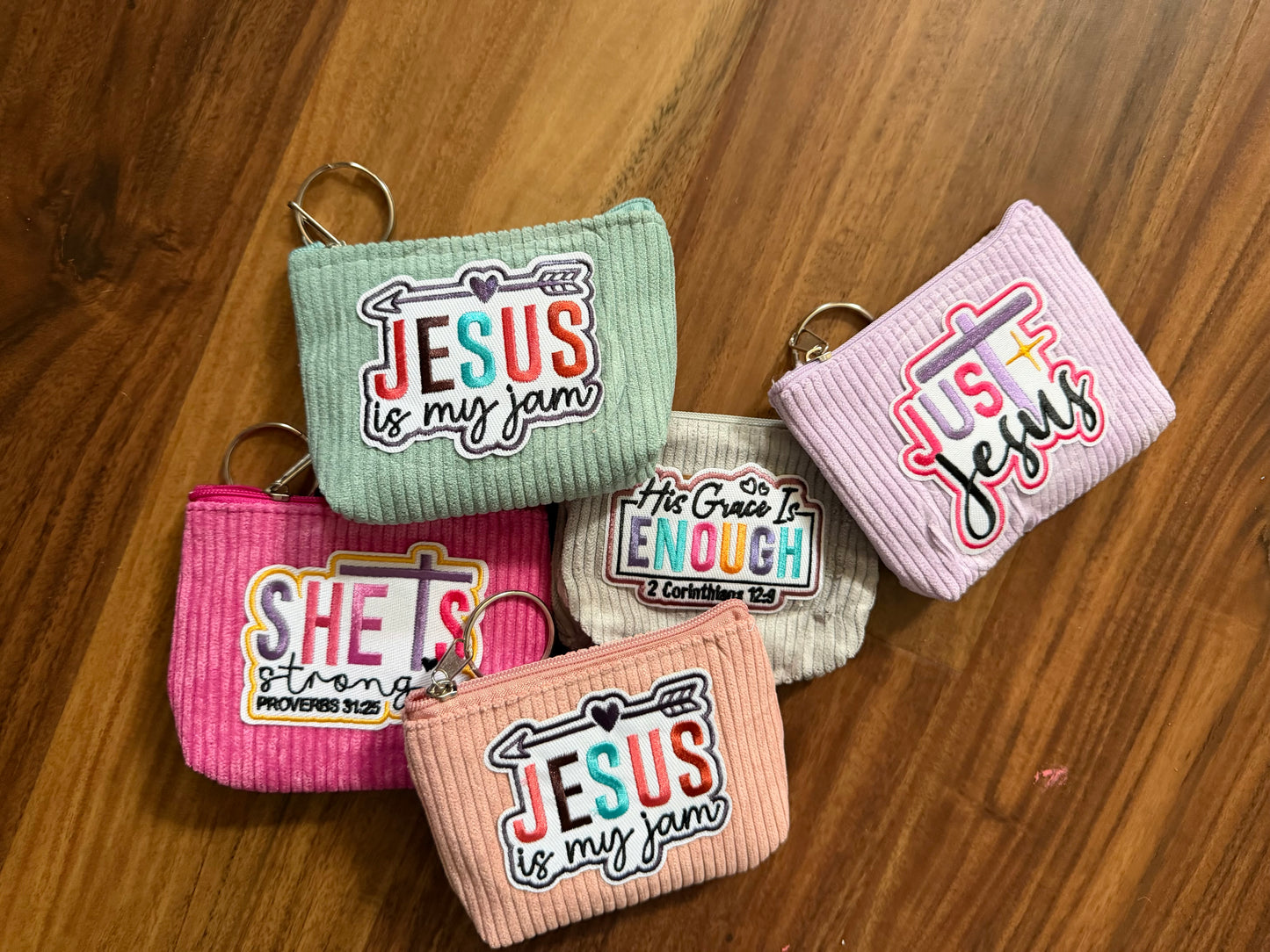Colorful corduroy coin purse with Christian patch, accessories by Sons & Daughters, featuring vibrant fabric and decorative details.