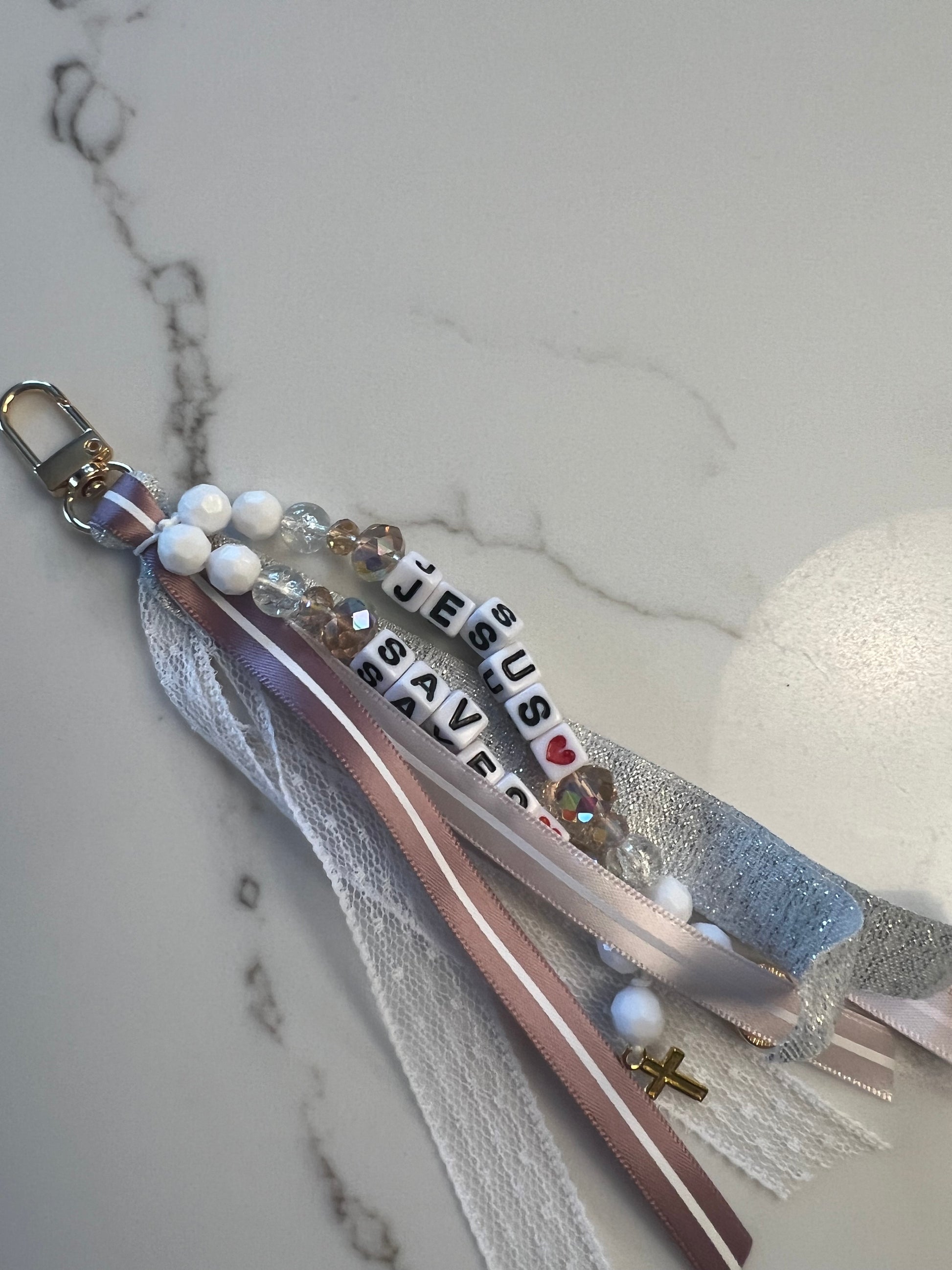 Whimsical Jesus Saves keychain by Sons & Daughters, featuring a playful Jesus design on a metal keyring.