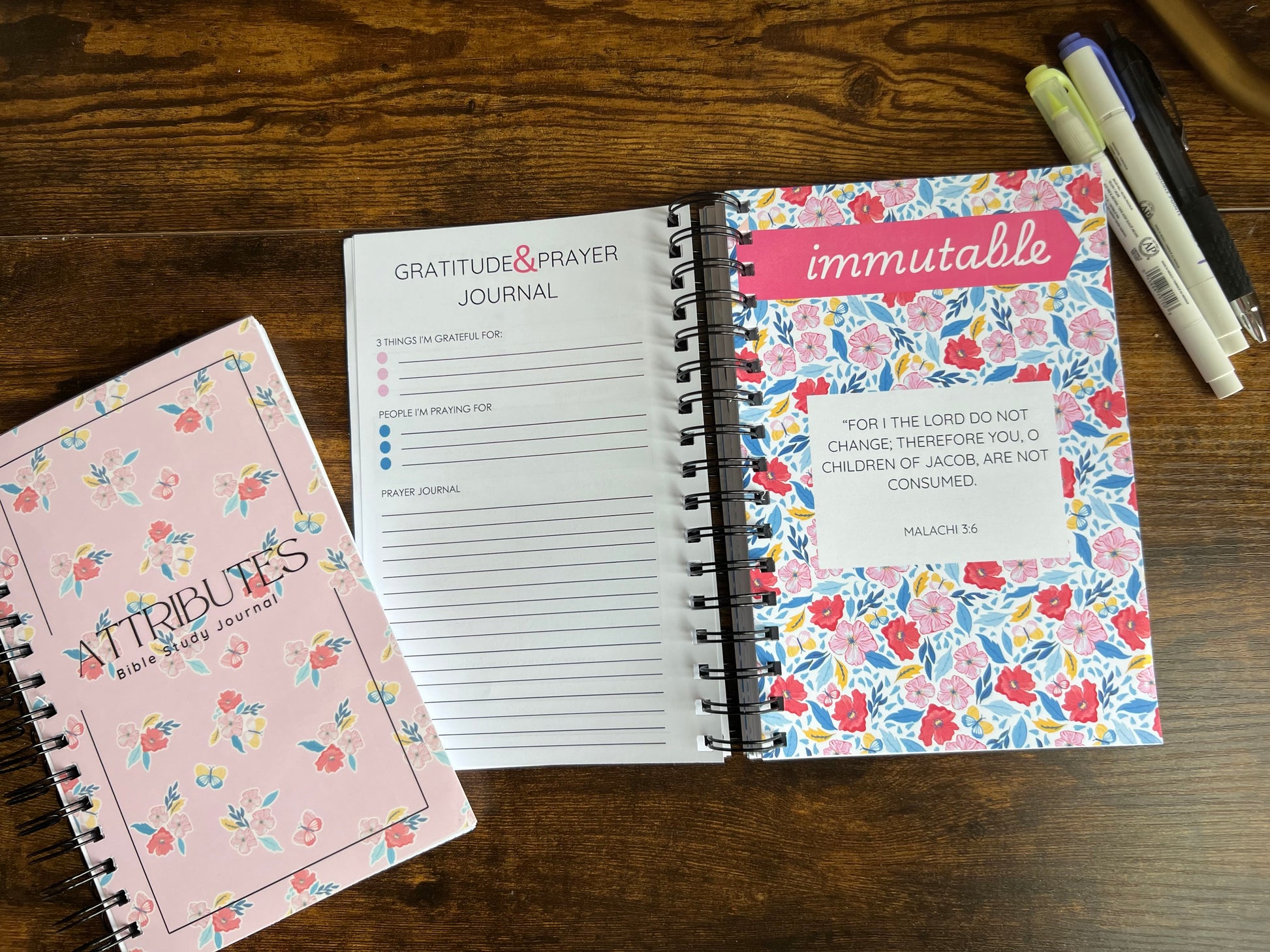 Spiral edition Bible study journal titled "Attributes of God" by Sons & Daughters, featuring a decorative cover and lined pages inside.