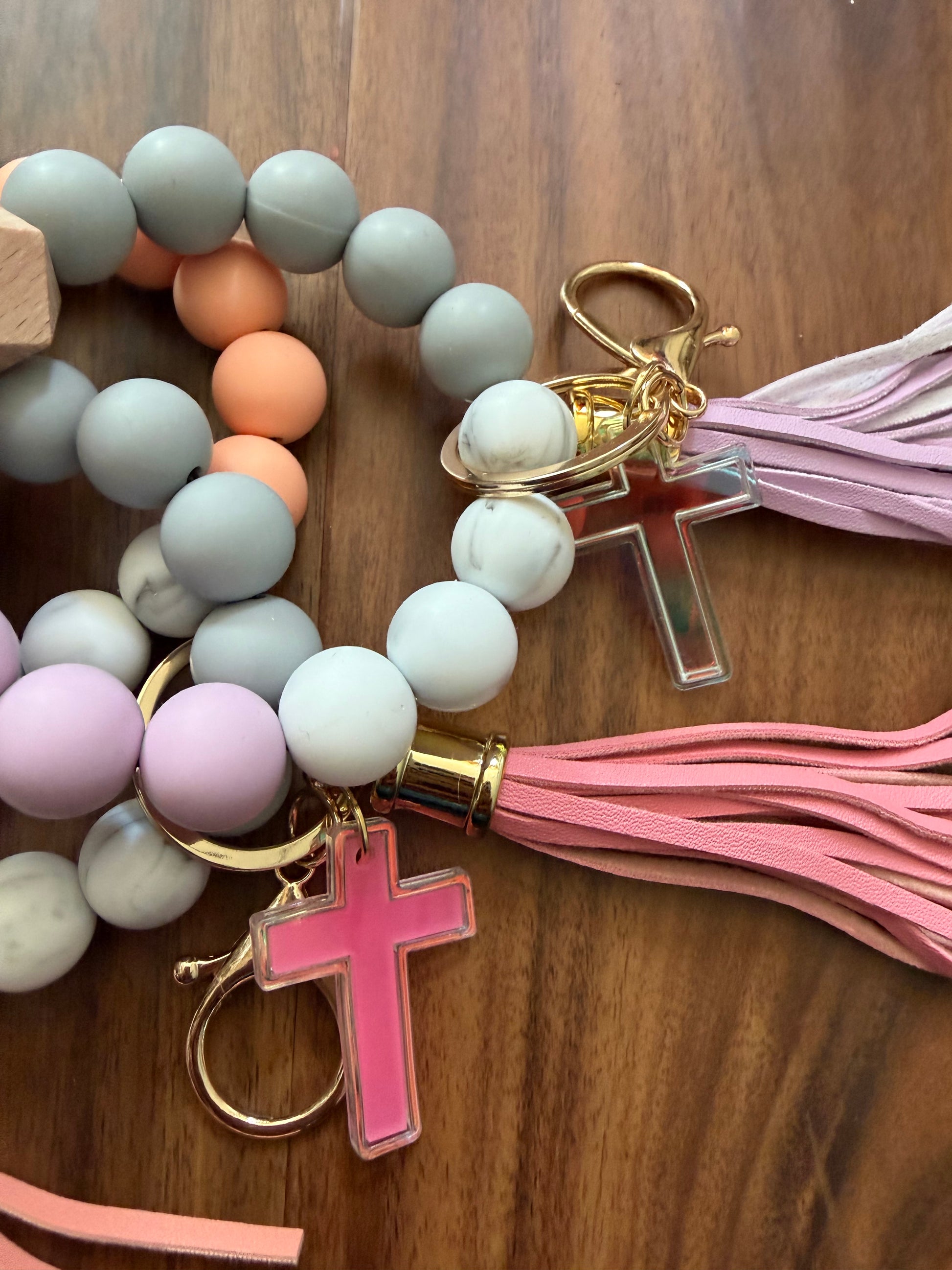 Silicone cross bracelet keychain by Sons & Daughters, durable accessories with a religious cross design on a keyring.
