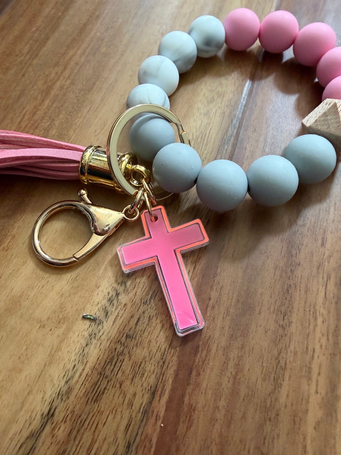 Silicone cross bracelet keychain from Sons & Daughters, colorful accessory with a cross design for everyday style.
