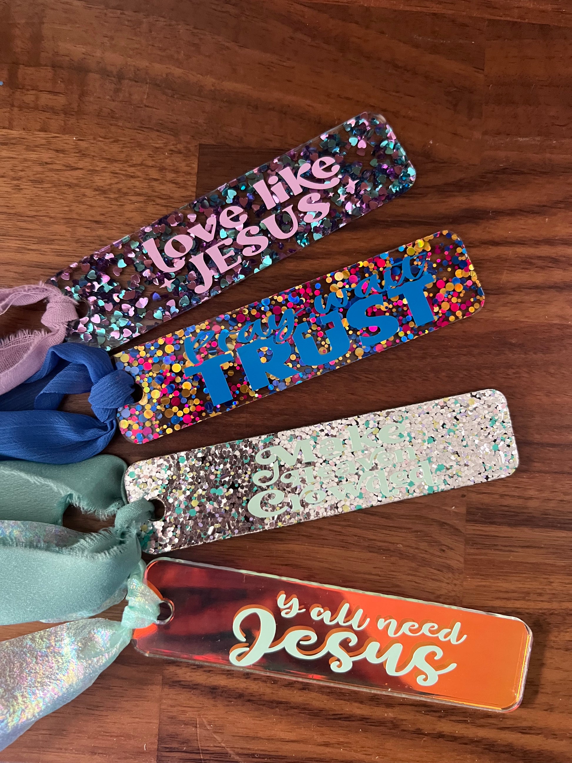Sons & Daughters Glittering Truth acrylic bookmark with shimmering design, perfect for gift-giving or adding sparkle to reading.