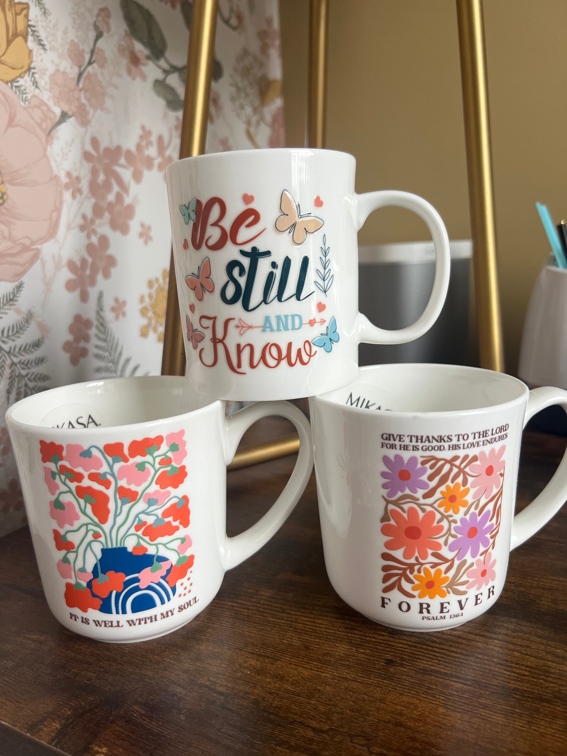 White ceramic mug and clear glass can from Sons & Daughters, displayed side by side.