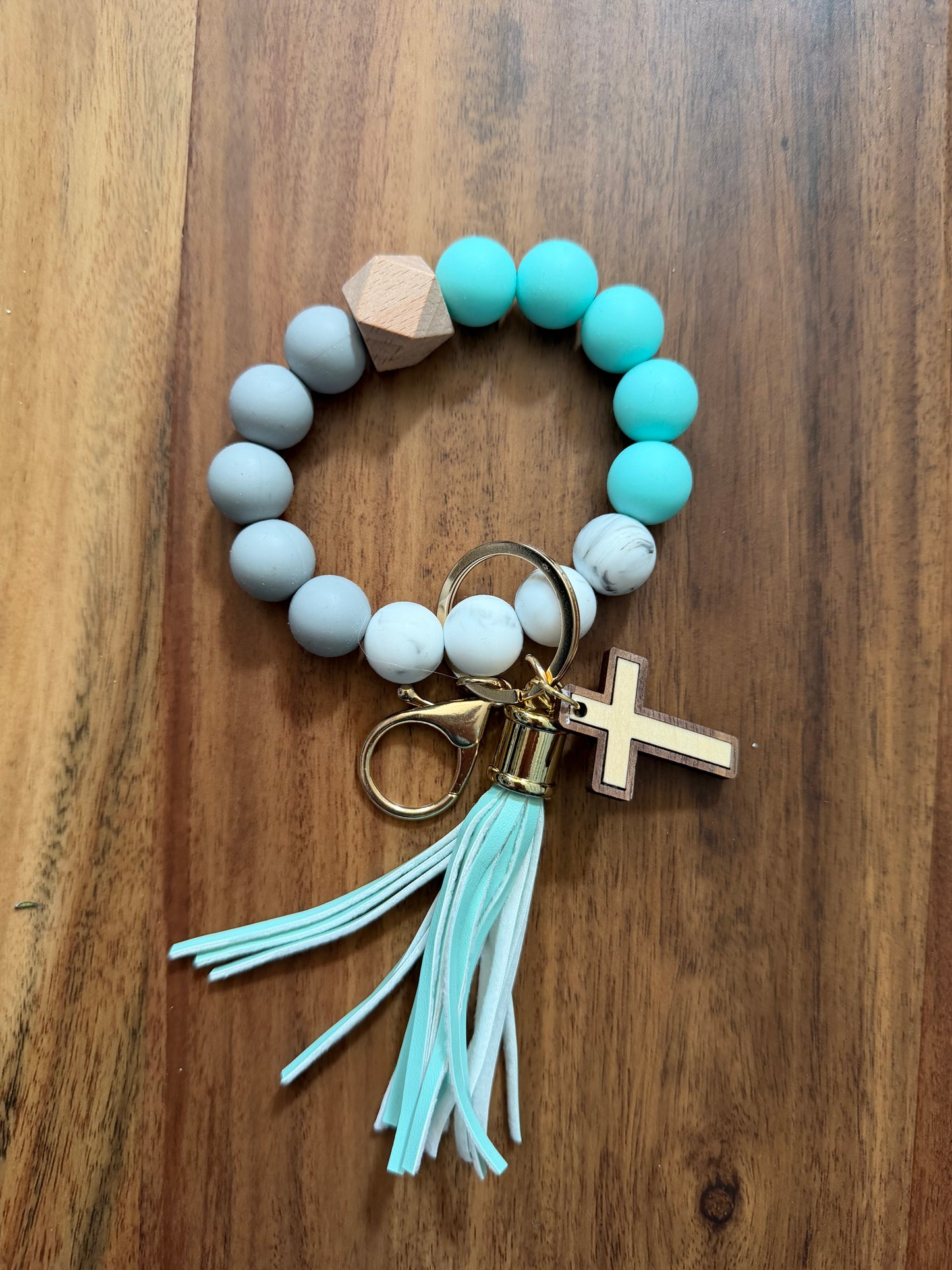 Silicone cross bracelet keychain from Sons & Daughters accessories collection, featuring a colorful cross design.