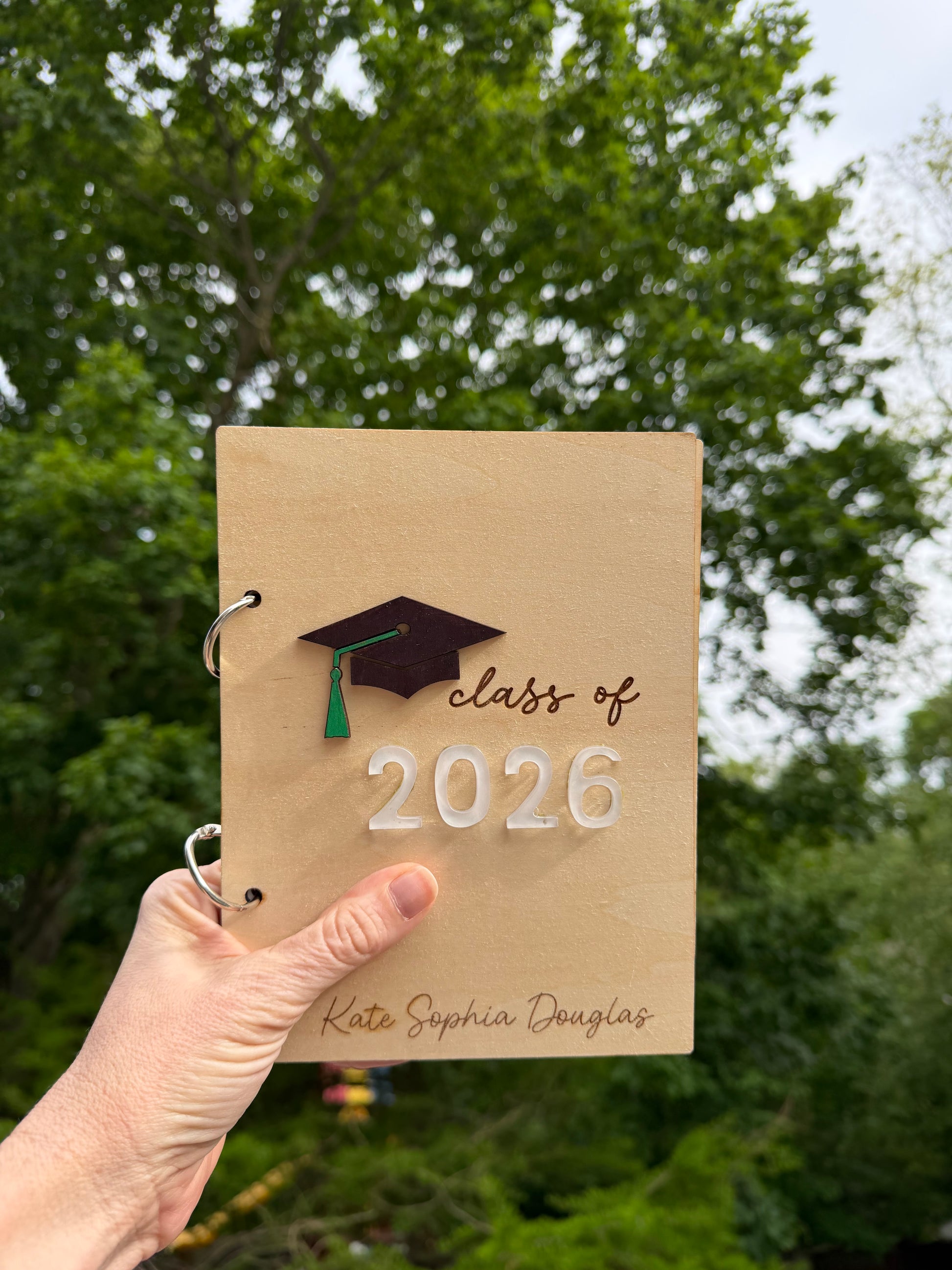 Personalized wooden graduation card holder with engraved "2026" and Bible verse option, ideal for keepsake gift from Sons & Daughters.