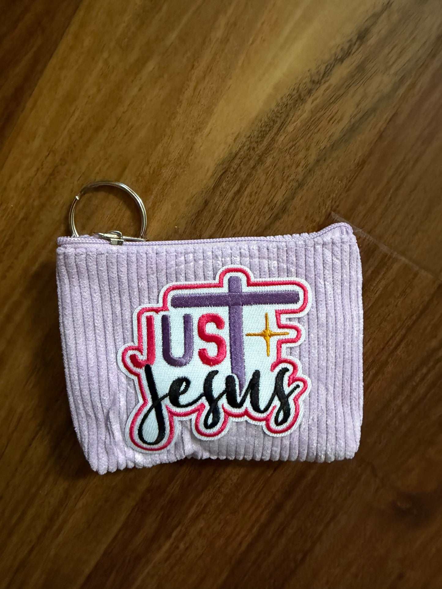 Colorful corduroy coin purse with Christian patch from Sons & Daughters accessories collection, featuring vibrant fabric and detailed patch design.