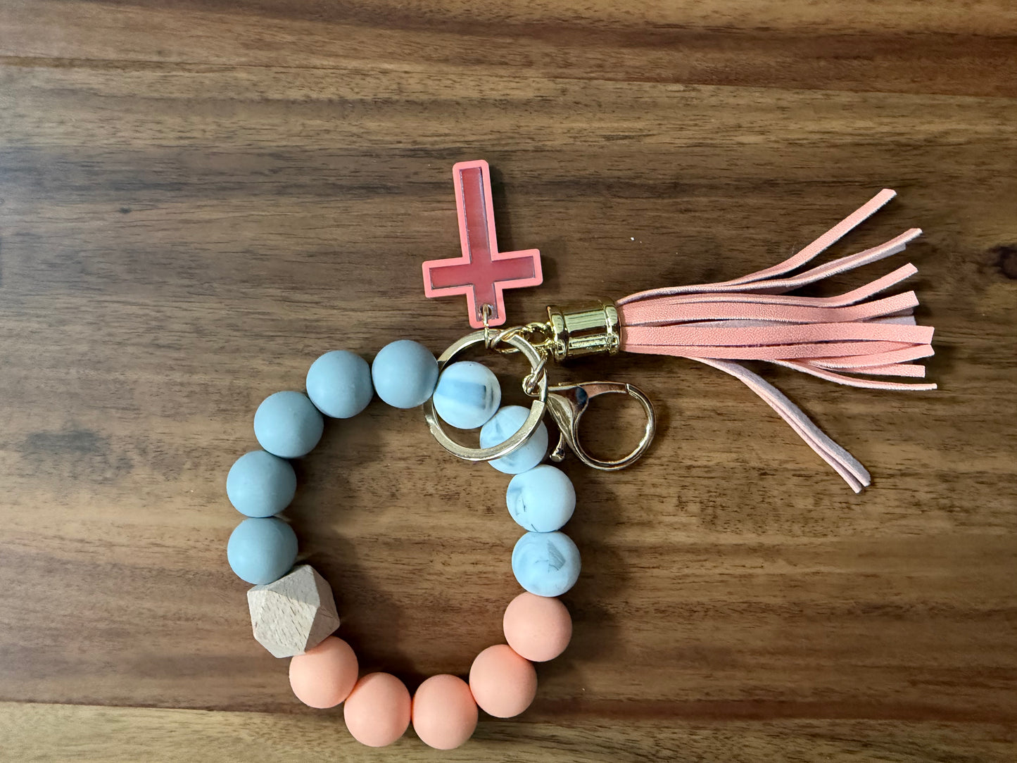 Silicone Cross bracelet keychain from Sons & Daughters accessories, featuring a colorful cross design on a durable keychain.
