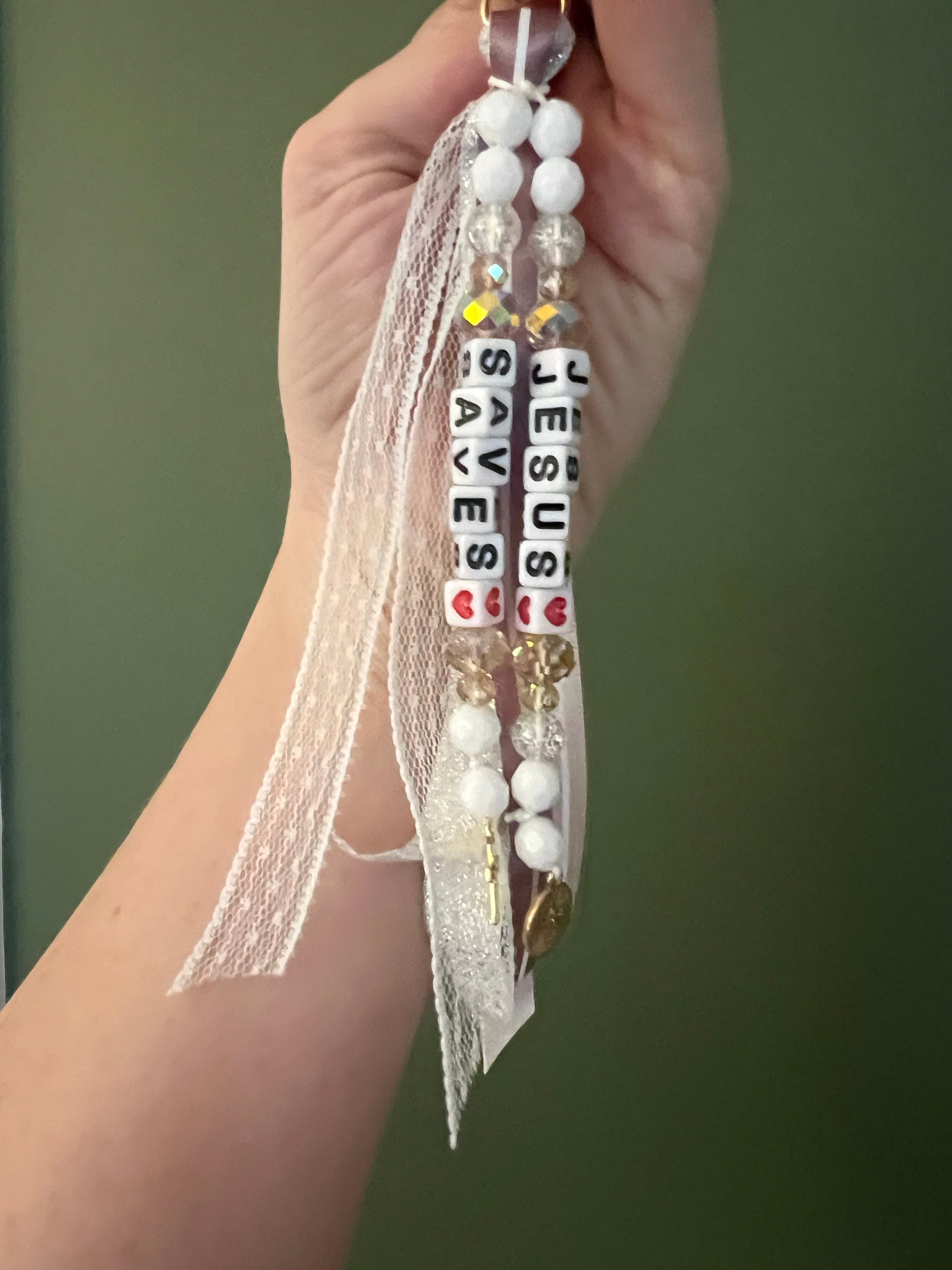 Whimsical Jesus saves keychain by Sons & Daughters, featuring a playful Jesus figure on a metal keyring.