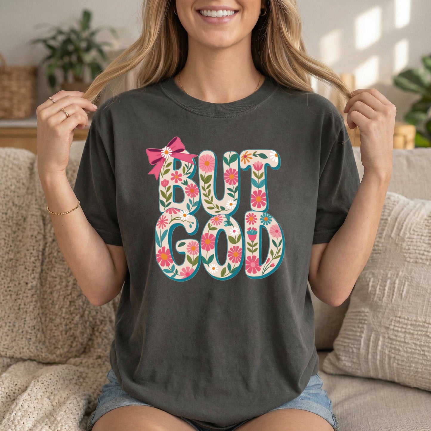 Charcoal Christian T-shirt by Sons & Daughters featuring floral design and inspirational Bible verse "But God" on soft cotton fabric.