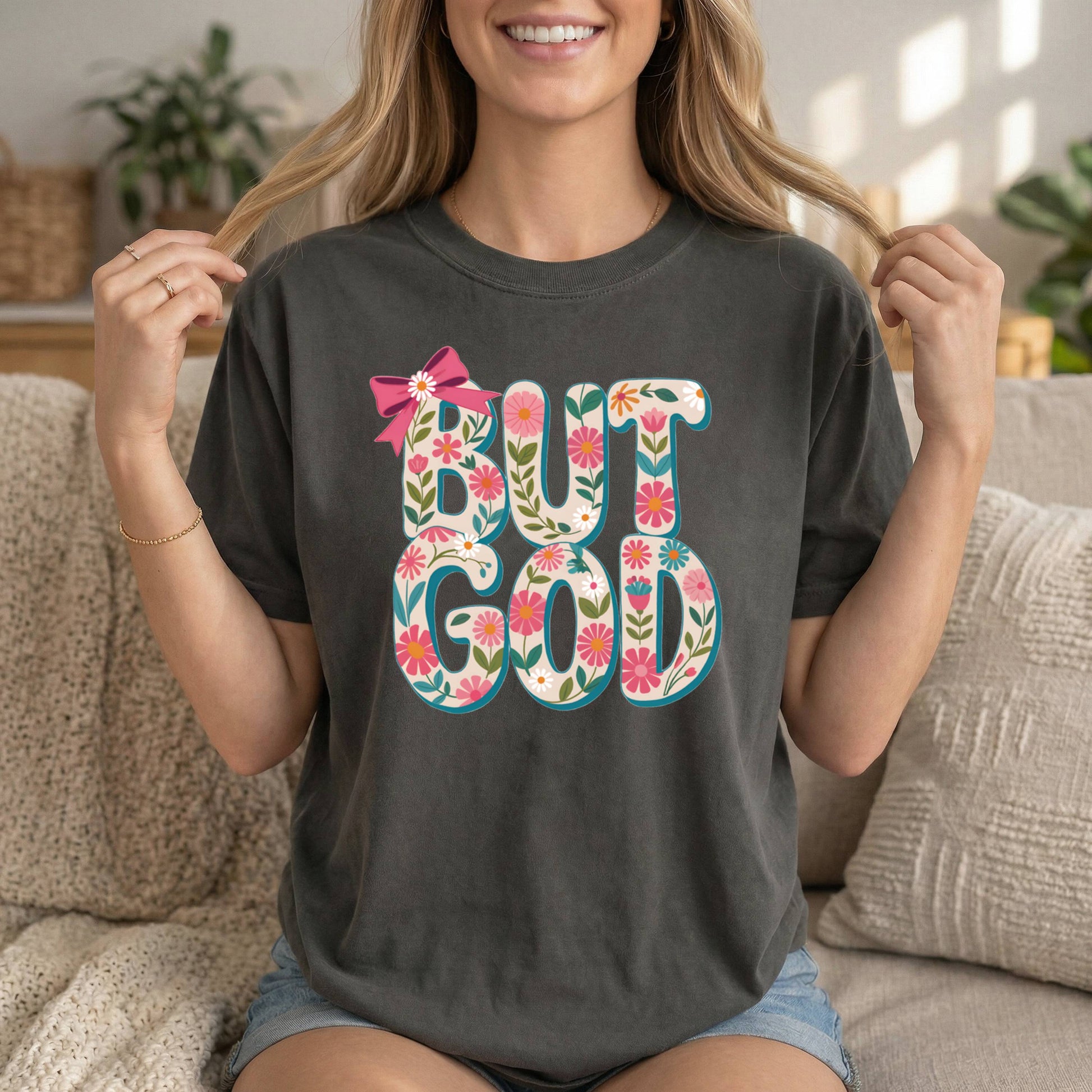 Charcoal Christian T-shirt by Sons & Daughters featuring floral design and inspirational Bible verse "But God" on soft cotton fabric.