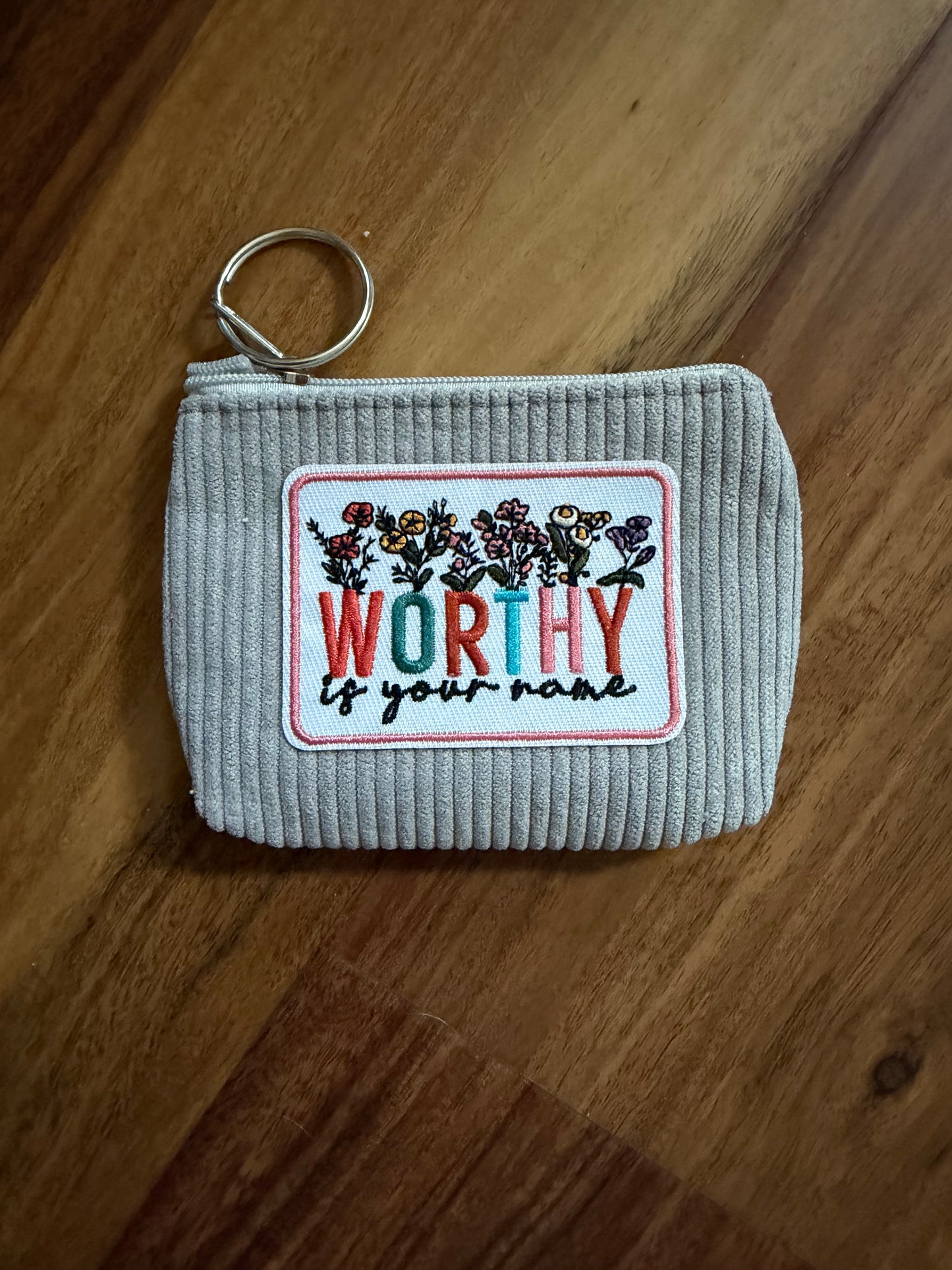 Colorful corduroy coin purse with Christian patch from Sons & Daughters accessories, showing vibrant fabric and detailed patch design.