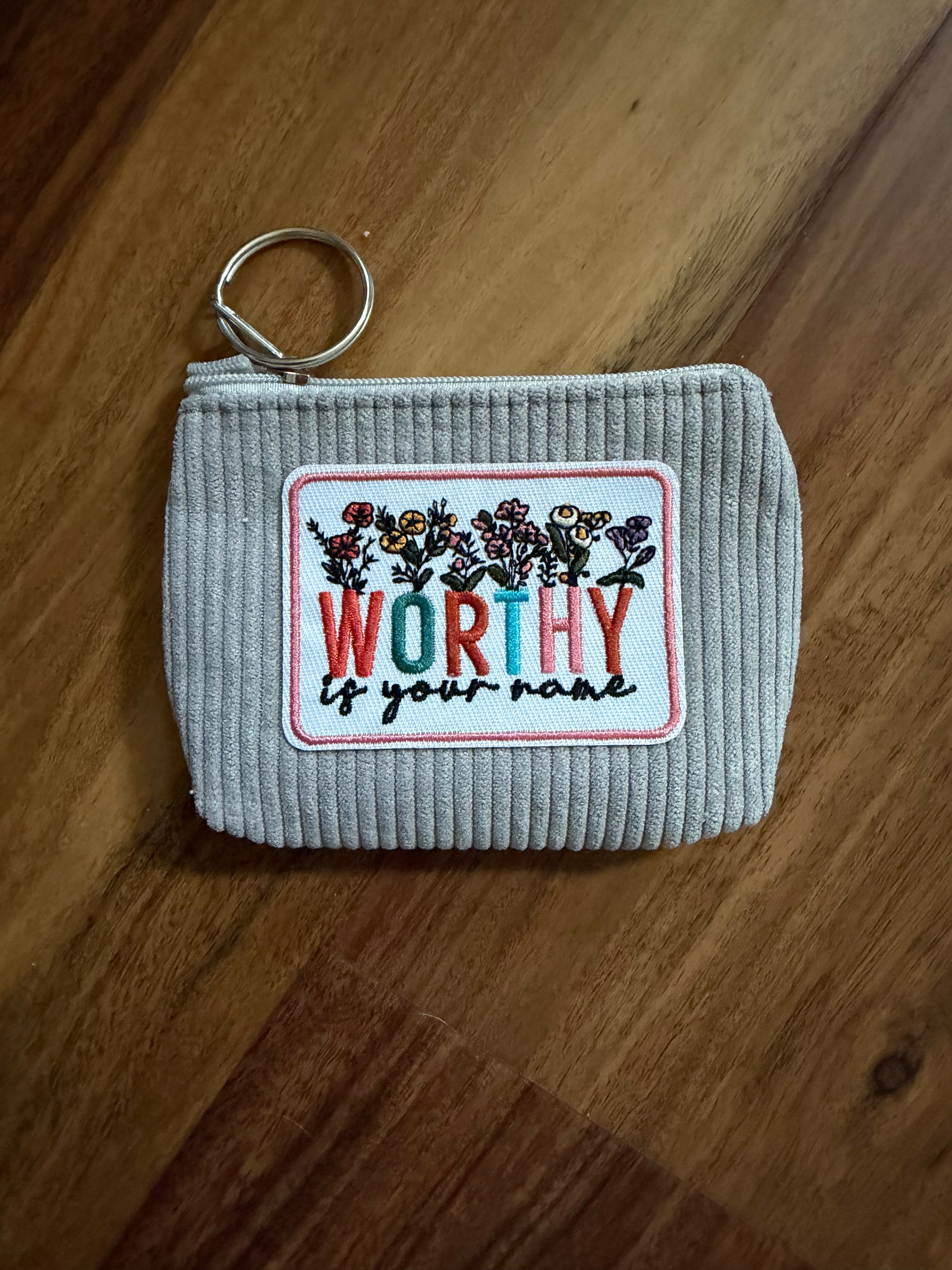 Colorful corduroy coin purse with Christian patch from Sons & Daughters accessories, showing vibrant fabric and detailed patch design.