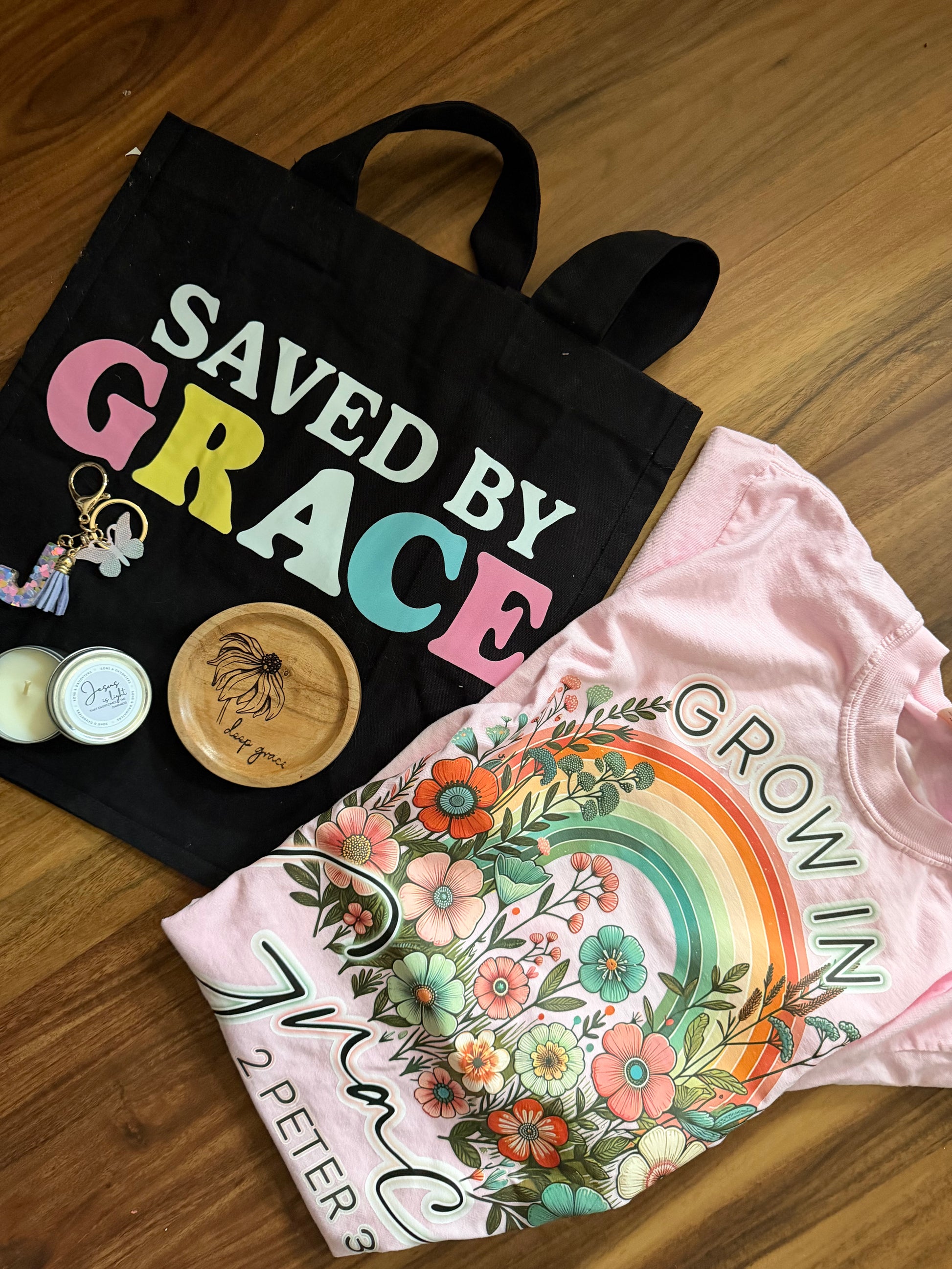 Mystery gift box with Grace theme from Sons & Daughters, includes spiritual soul care kit, t-shirt, and bag in a thoughtfully packaged set.