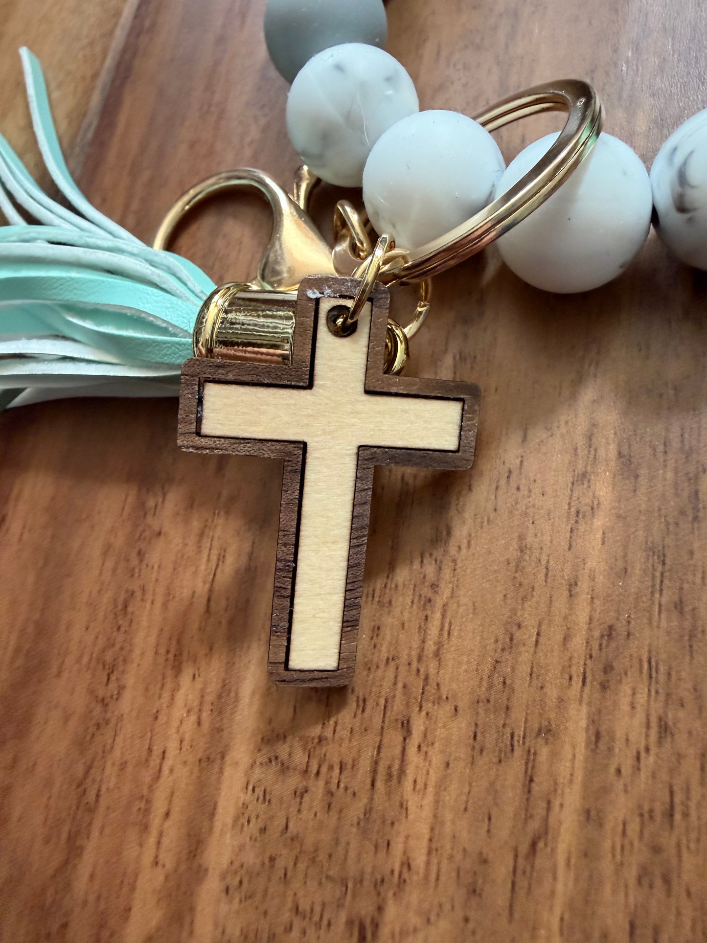 Silicone cross bracelet keychain accessory by Sons & Daughters with colorful design and durable material.
