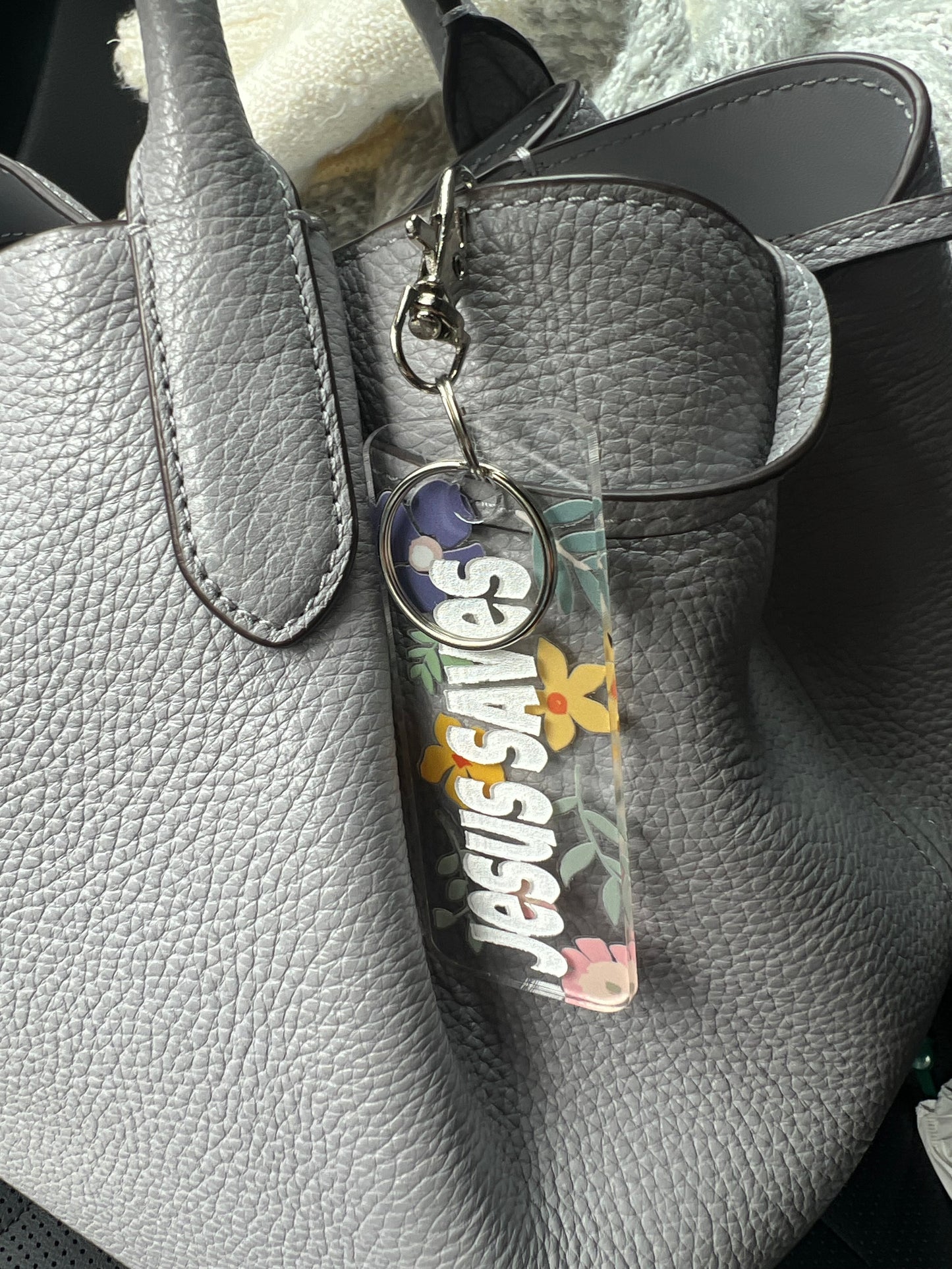 Sons & Daughters Kingdom keychain and bag tag featuring a detailed design with a crown motif on a metal keyring.