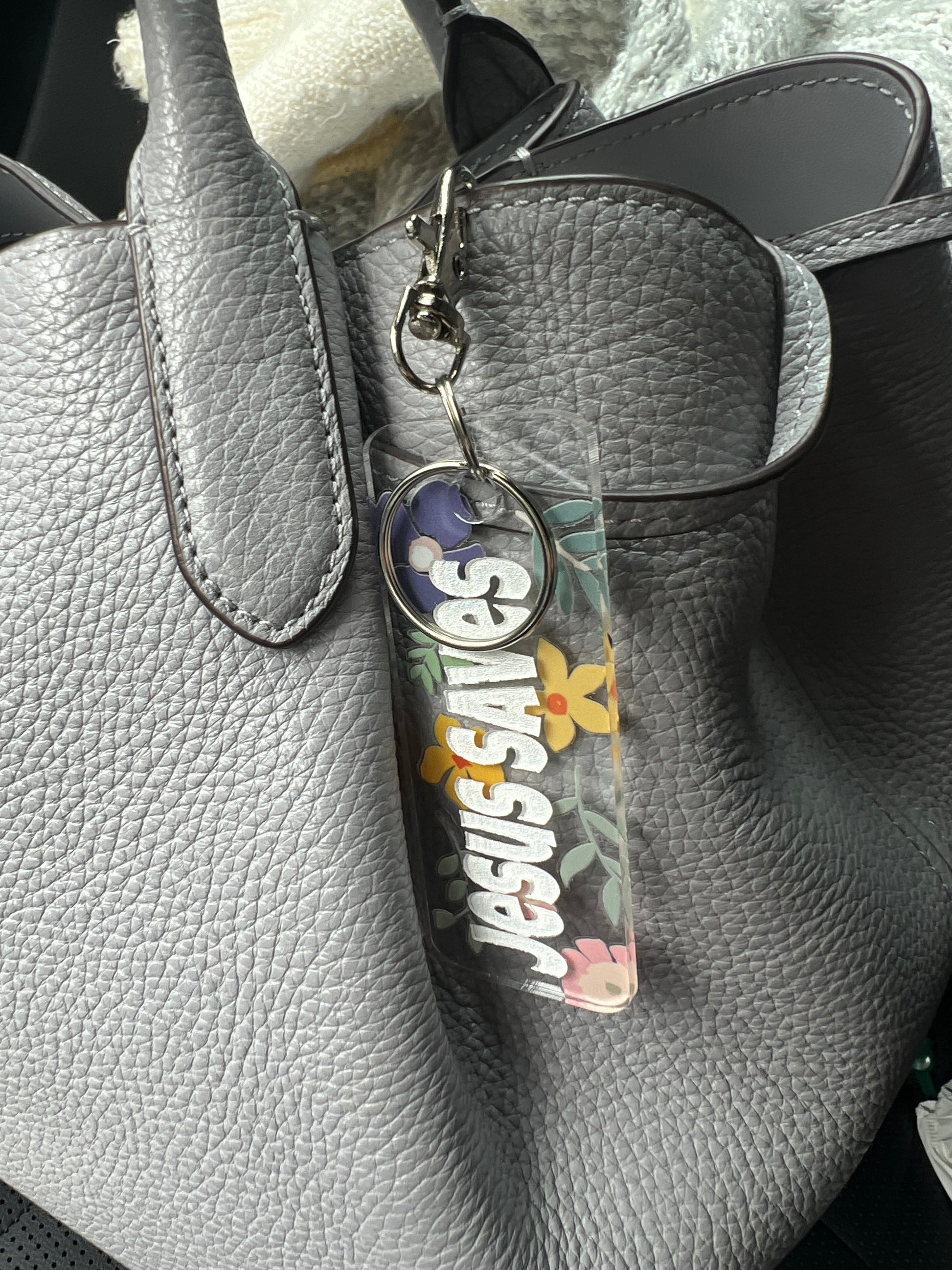 Sons & Daughters Kingdom keychain and bag tag featuring a detailed design with a crown motif on a metal keyring.