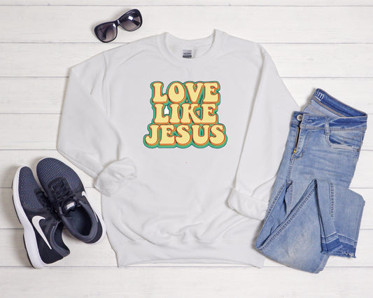 Sons & Daughters Love Like Jesus crew sweatshirt with printed message and soft fabric, shown in a close-up on a white background.