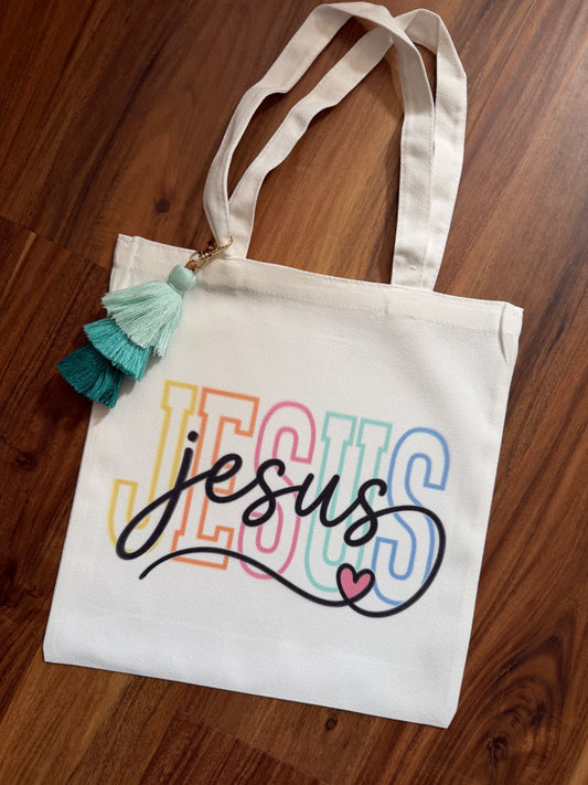 Color Jesus Canvas tassel Bible study bag by Sons & Daughters with vibrant design and tassel accents, perfect for carrying your Bible.