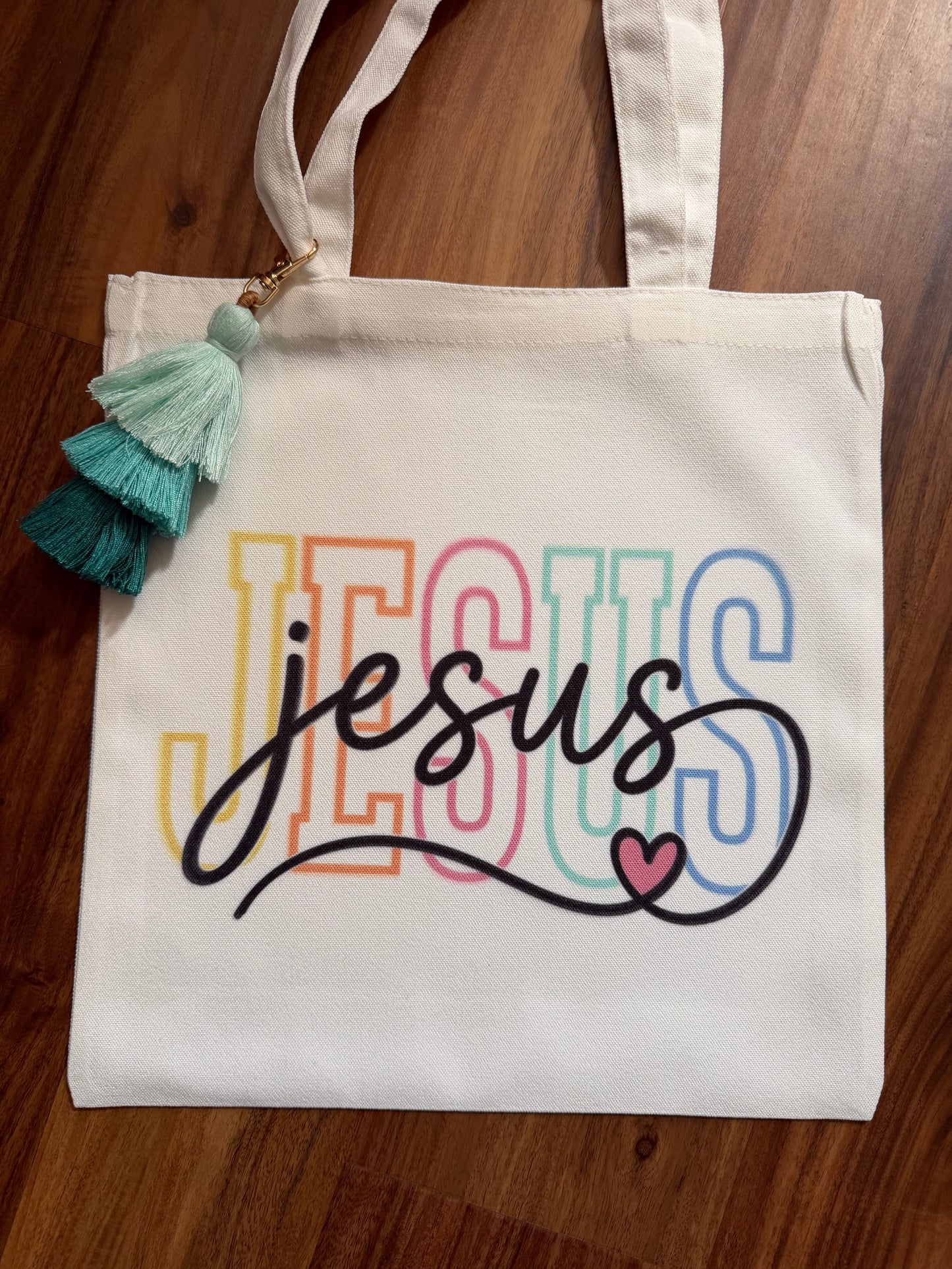 Color Jesus Canvas tassel Bible study bag with leather accents, featuring a spacious design and decorative tassels by Sons & Daughters.