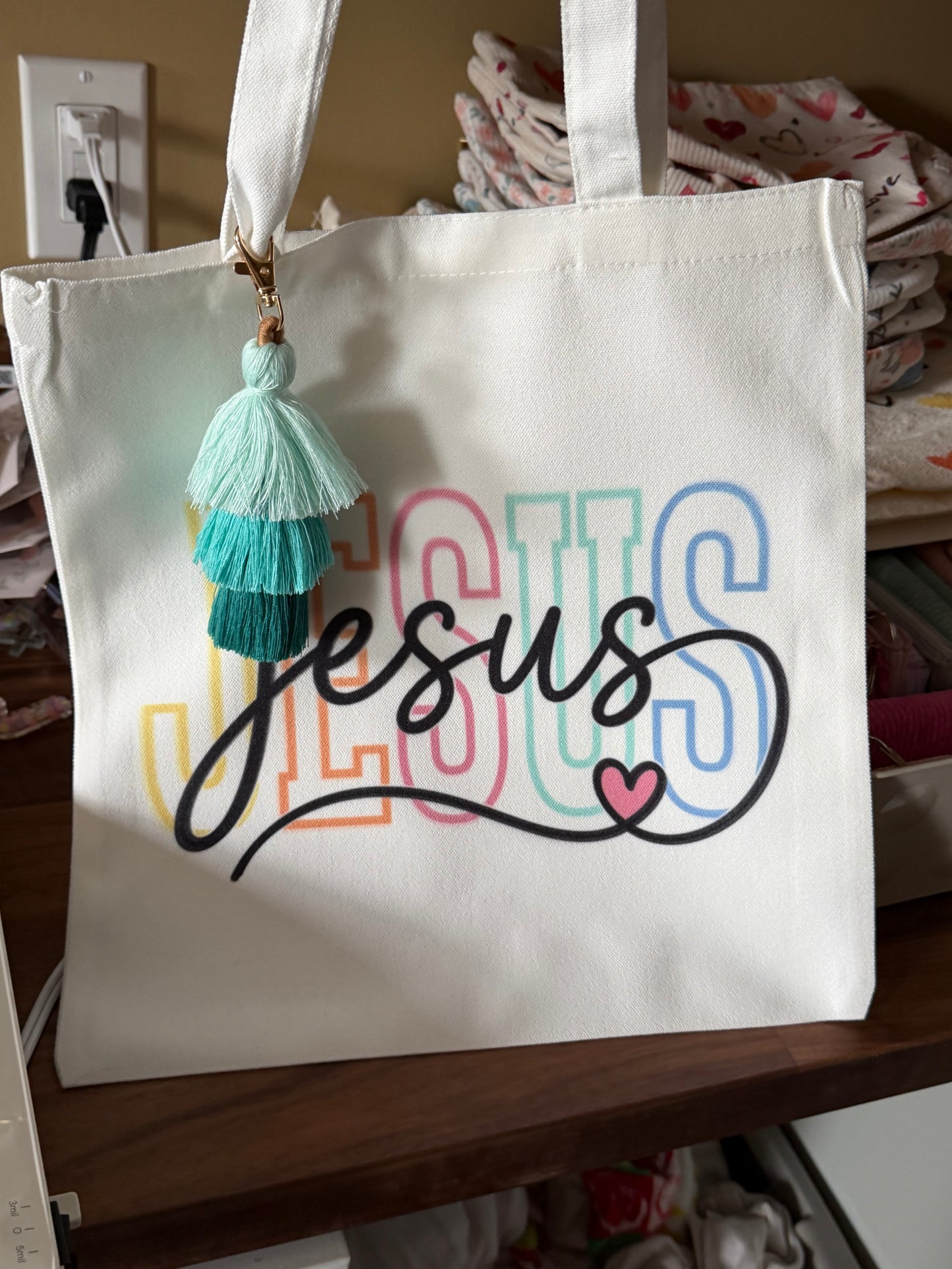 Color Jesus Canvas tassel Bible study bag by Sons & Daughters featuring a vibrant print, tassel accents, and sturdy handles.