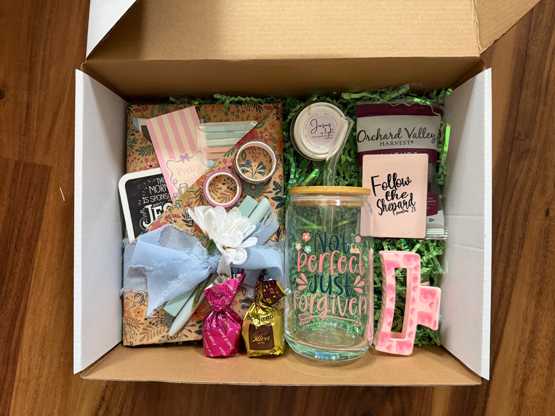 Sons & Daughters devotional surprise box titled "Blind Date with Jesus" featuring a wrapped mystery book with decorative wrapping and label.