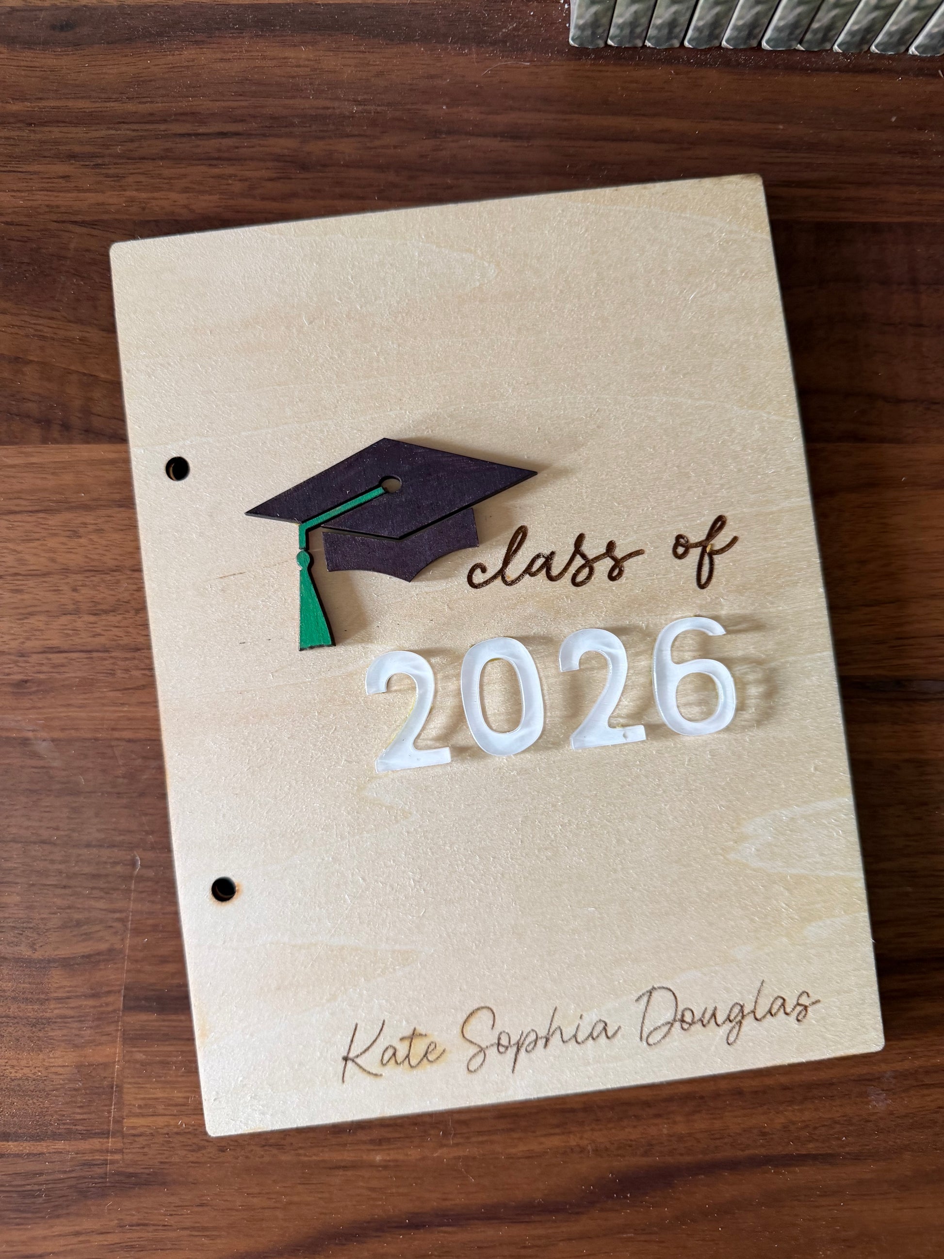Personalized wooden graduation card holder with engraved "2026" and Bible verse option, a custom keepsake gift for graduates by Sons & Daughters.