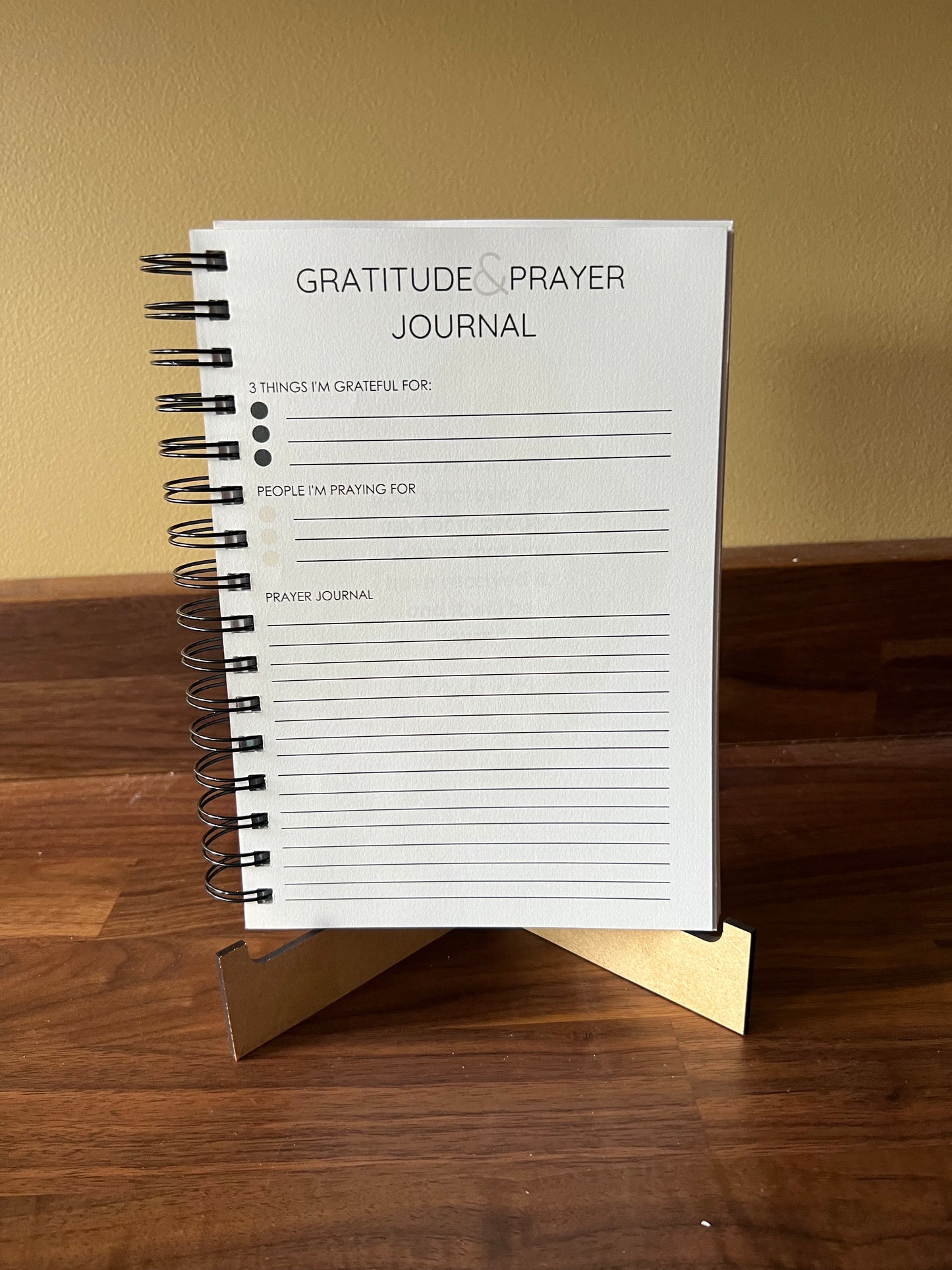 Blue Promises of God Bible Study Journal Spiral Edition by Sons & Daughters, featuring a cover with religious symbols and lined pages inside.