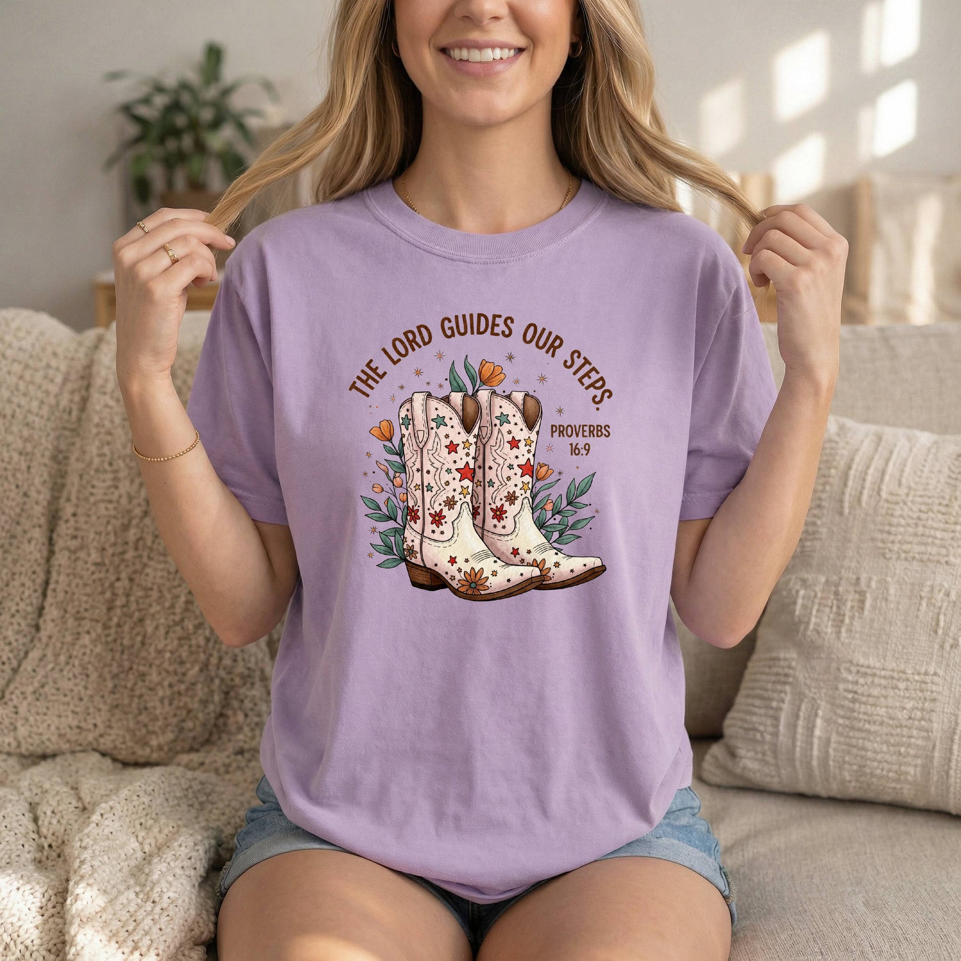 Lilac Comfort Colors Cowgirl T-Shirt by Sons & Daughters featuring boots graphic and Proverbs 16:9 Bible verse for women.