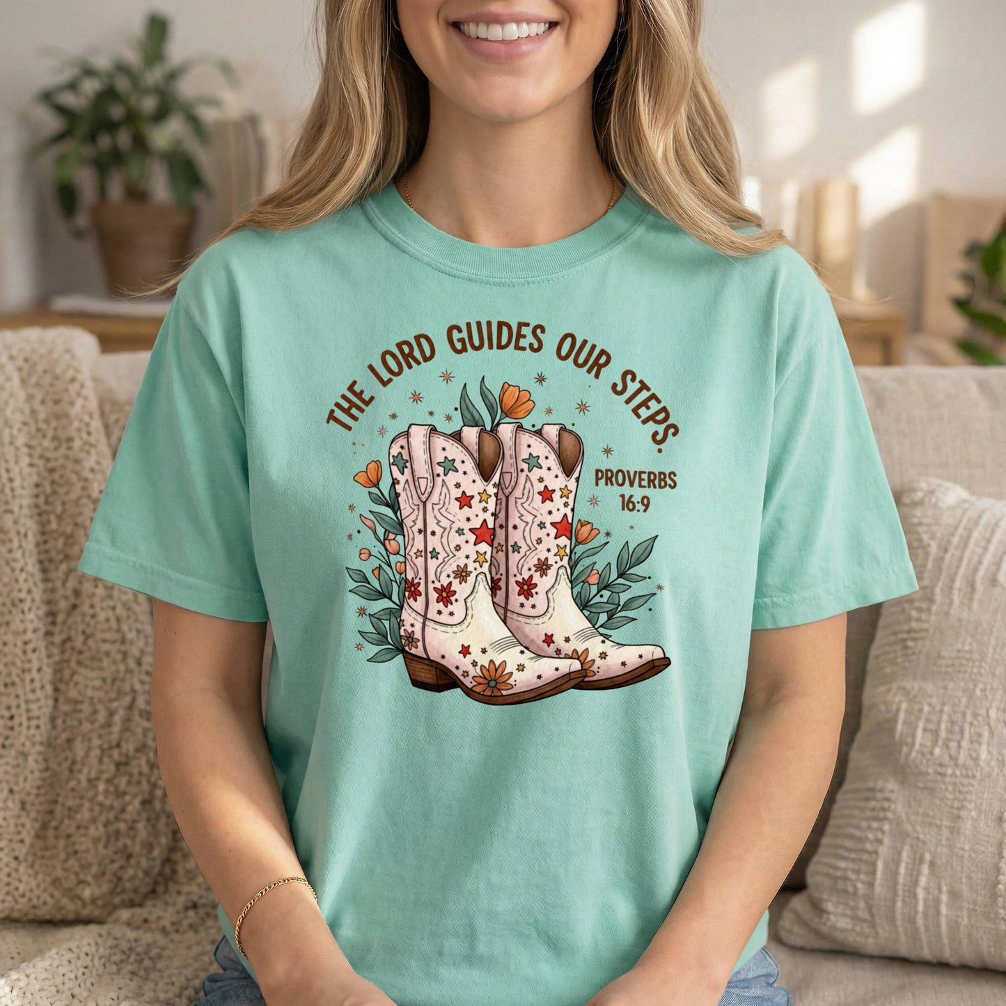 Mint Comfort Colors Cowgirl T-Shirt by Sons & Daughters with Proverbs 16:9 Bible verse and floral design featuring boots.