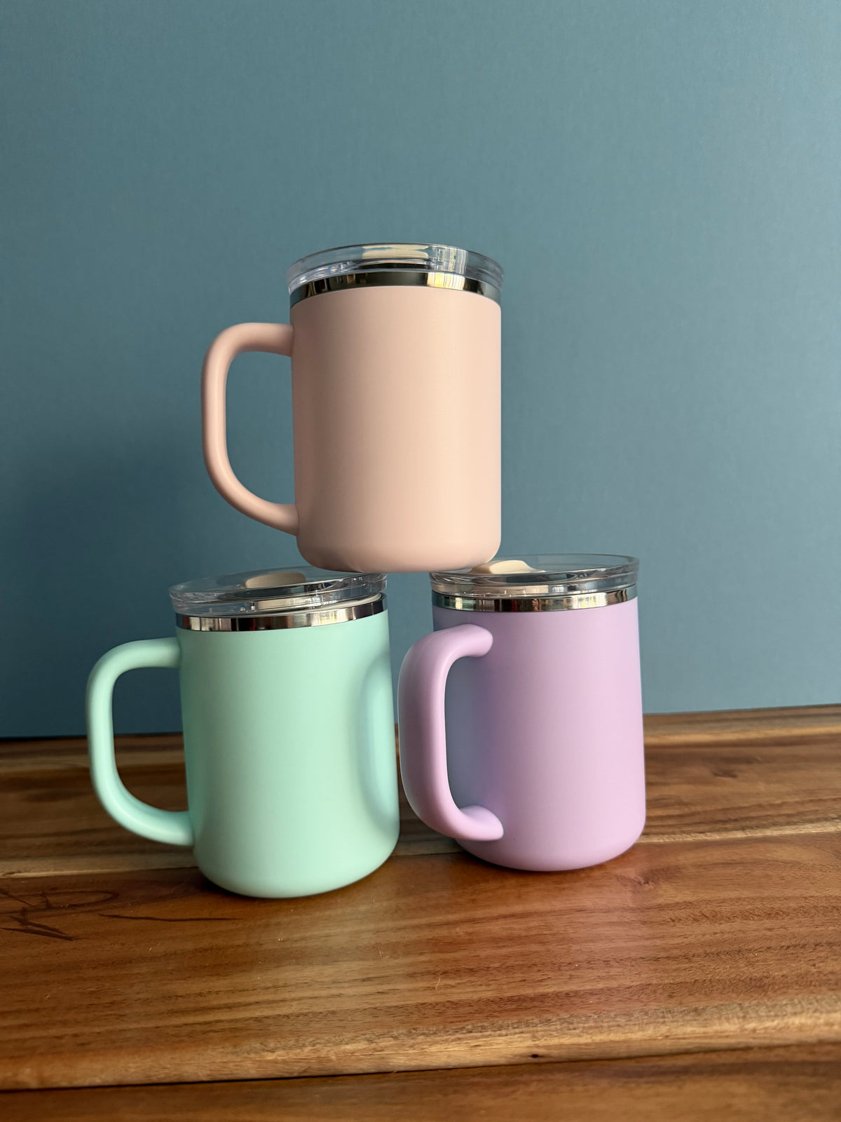 Sons & Daughters insulated mug in a simple library setting